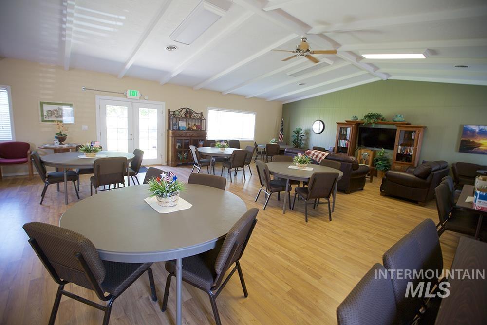 Dining area featuring french doors, wood finished floors, and a ceiling fan
