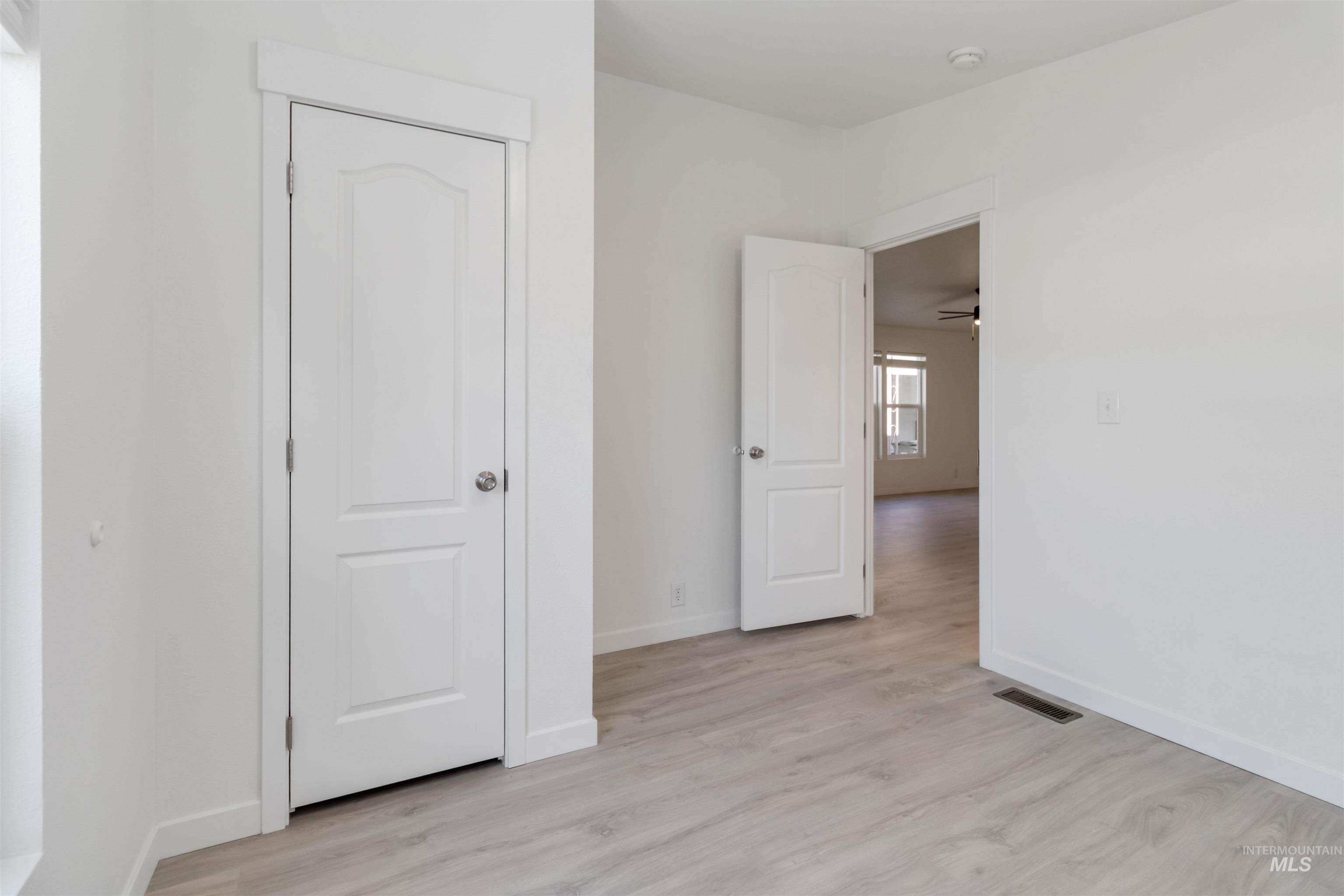 Unfurnished bedroom featuring light wood finished floors and baseboards