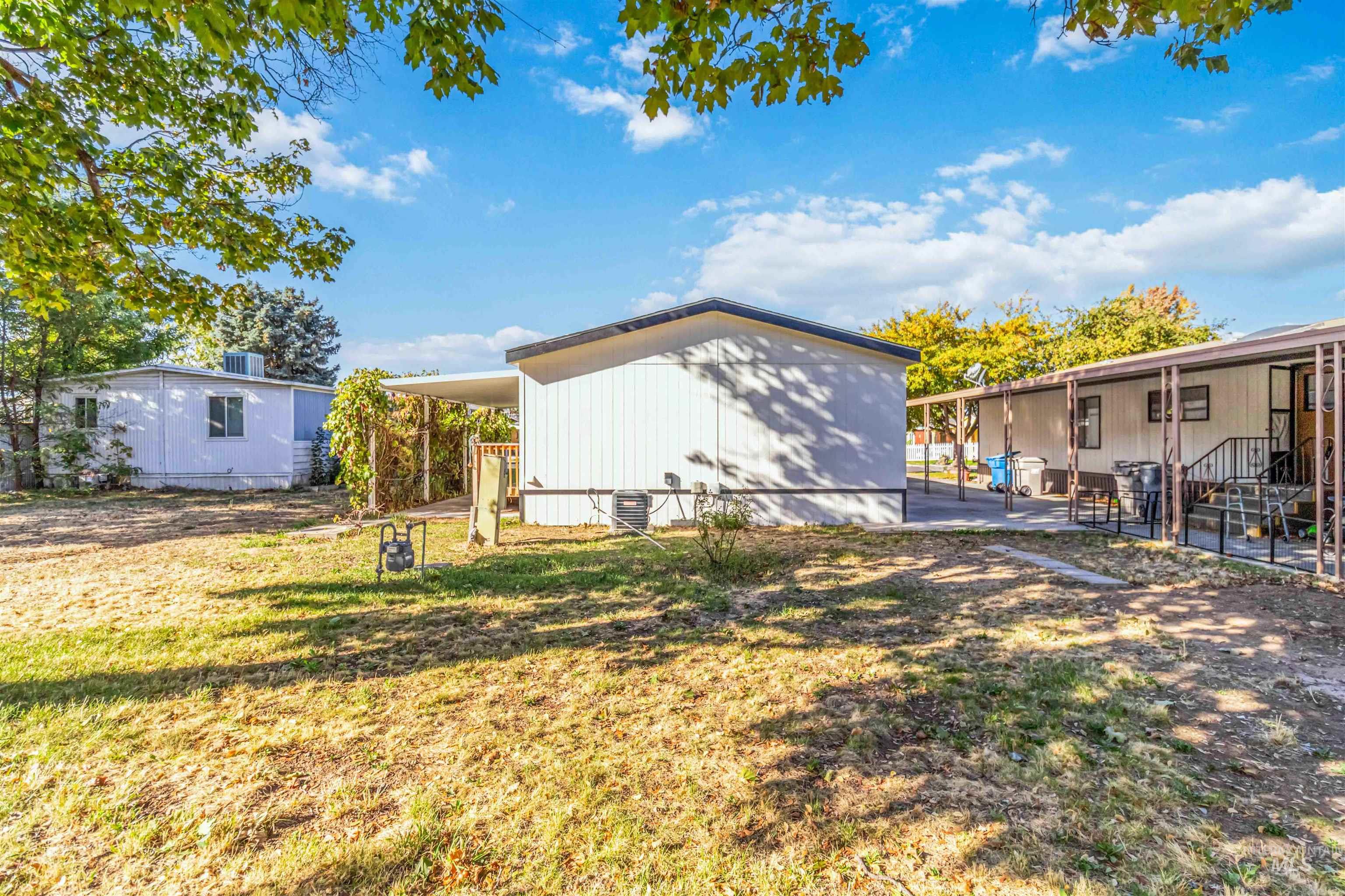 View of grassy yard with a patio area