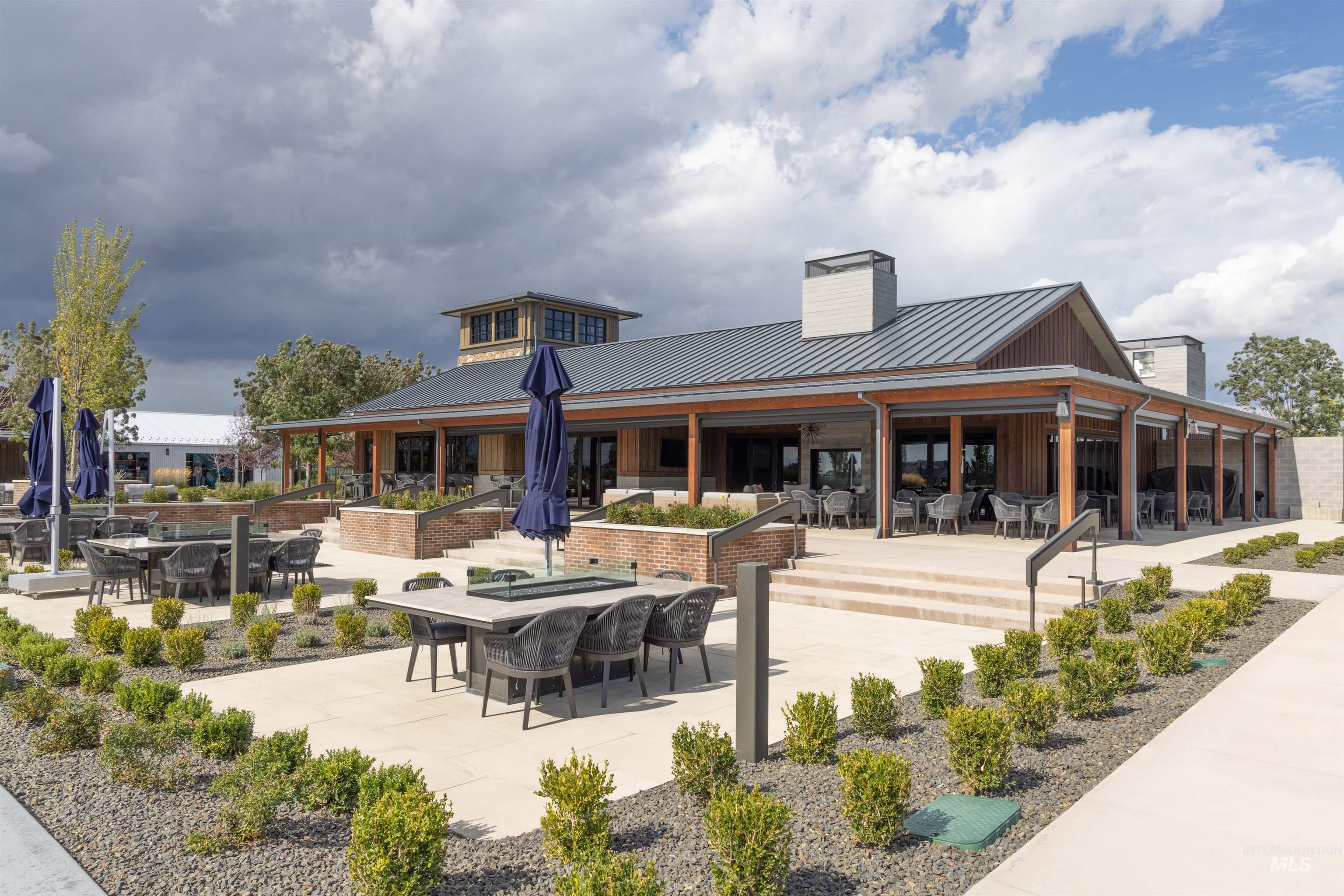 View of community featuring a patio and outdoor dining area