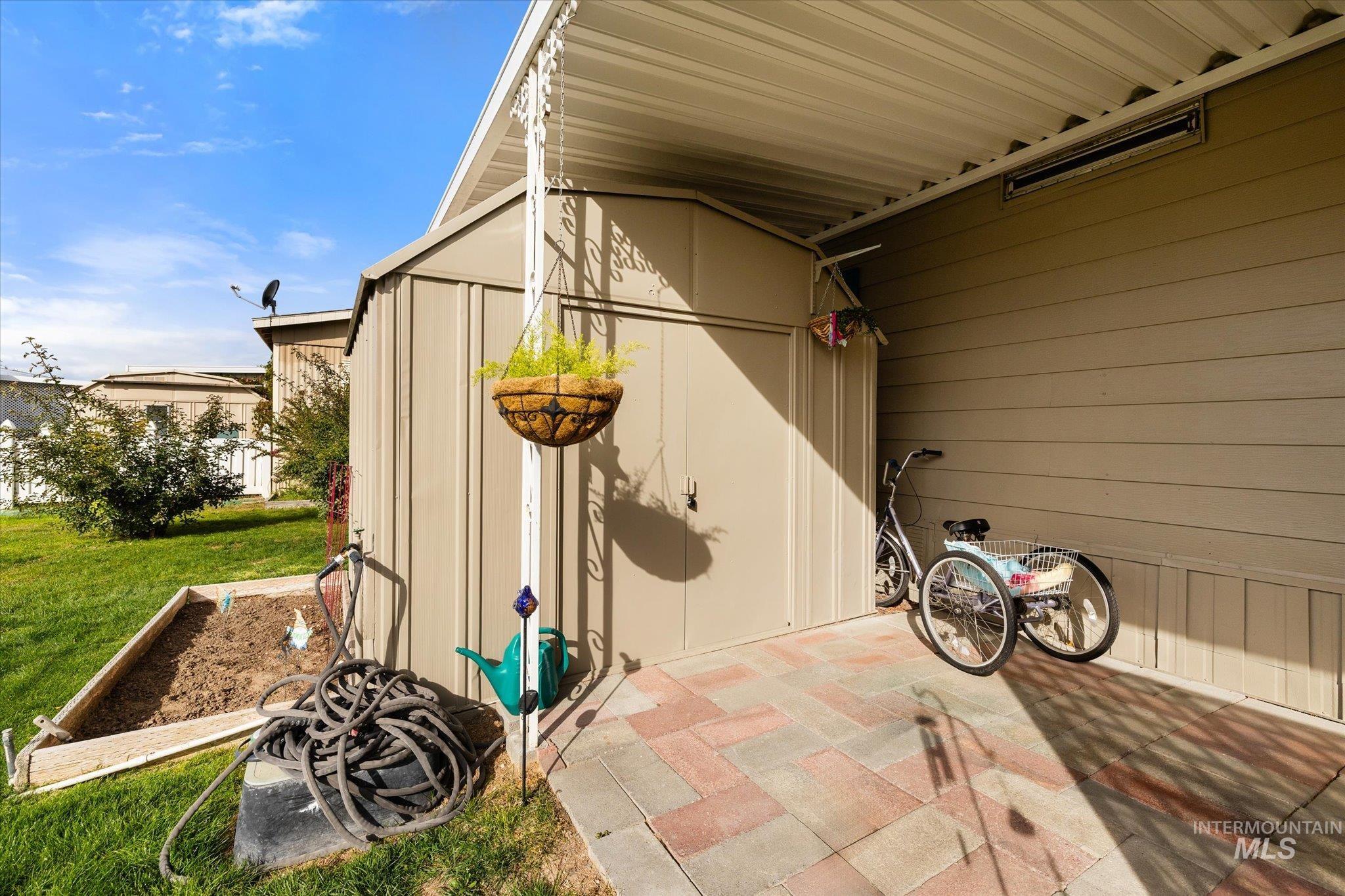 View of patio featuring a storage shed
