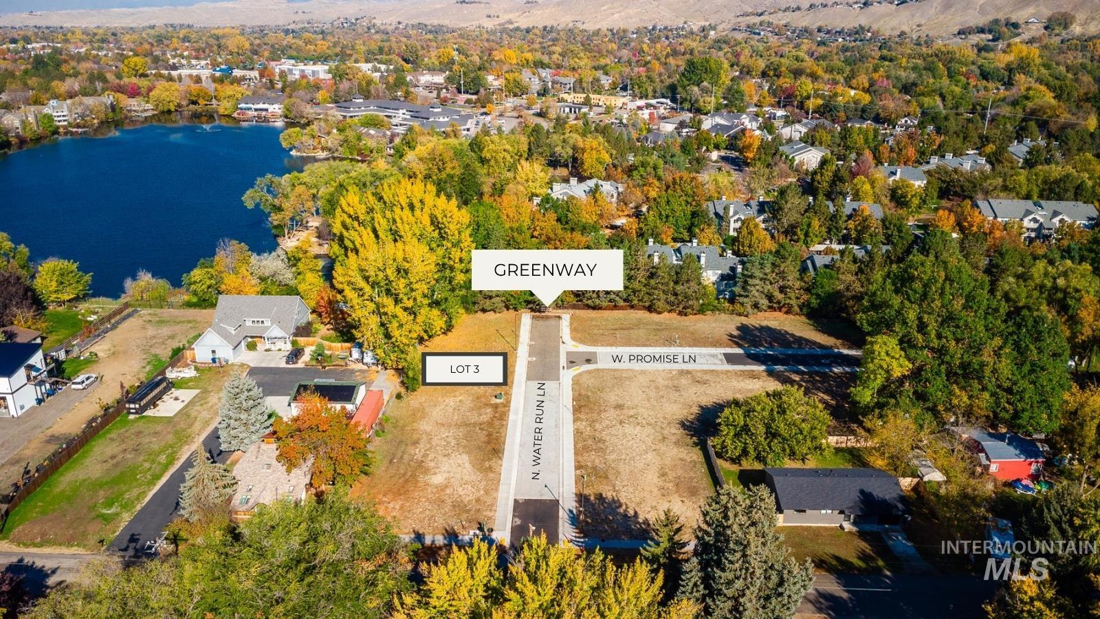 Aerial view of property's location featuring a large body of water and nearby suburban area