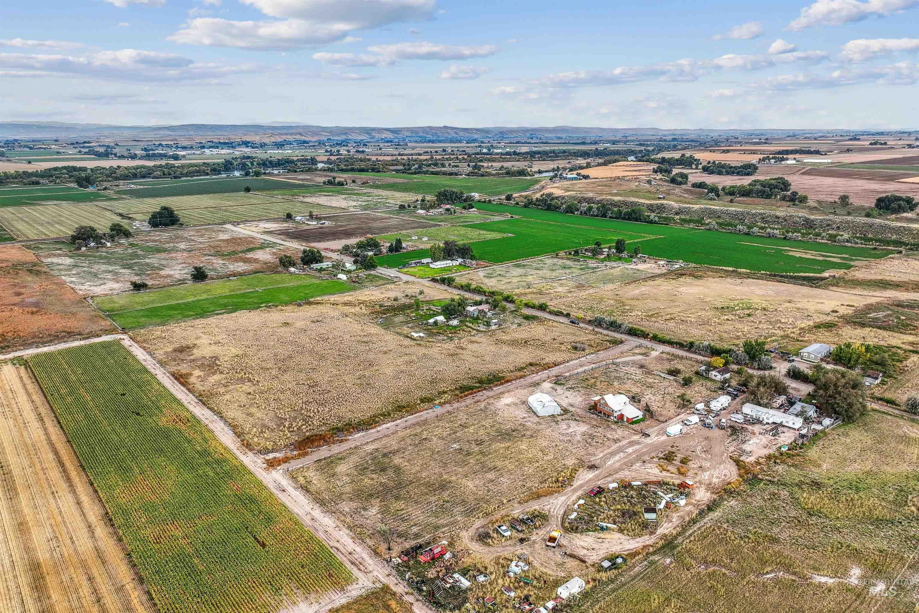 Aerial overview of property's location with rural landscape and large plots for crops