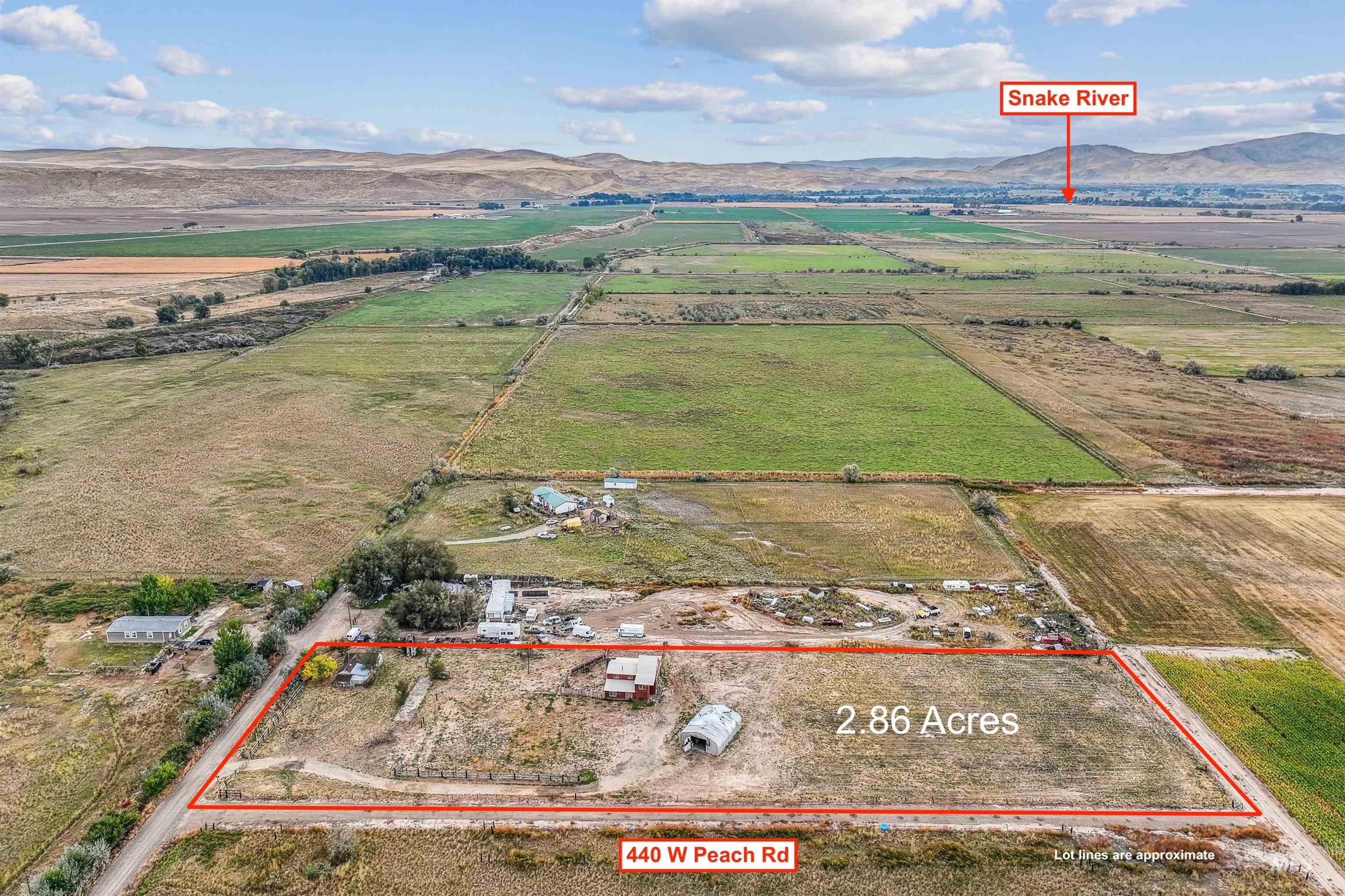 Overview of rural landscape with a mountainous background and property parcel outlined