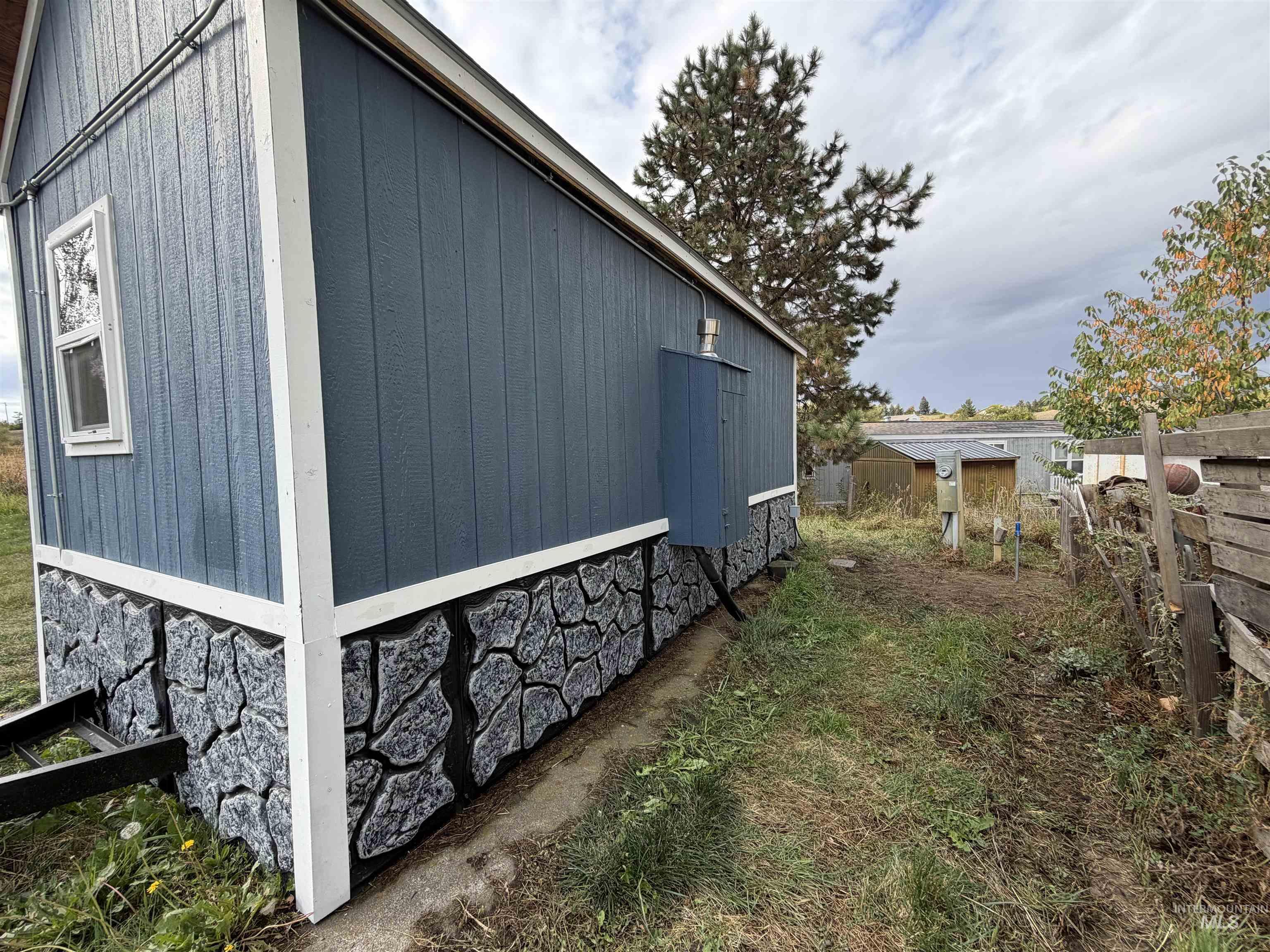 View of property exterior with an outbuilding