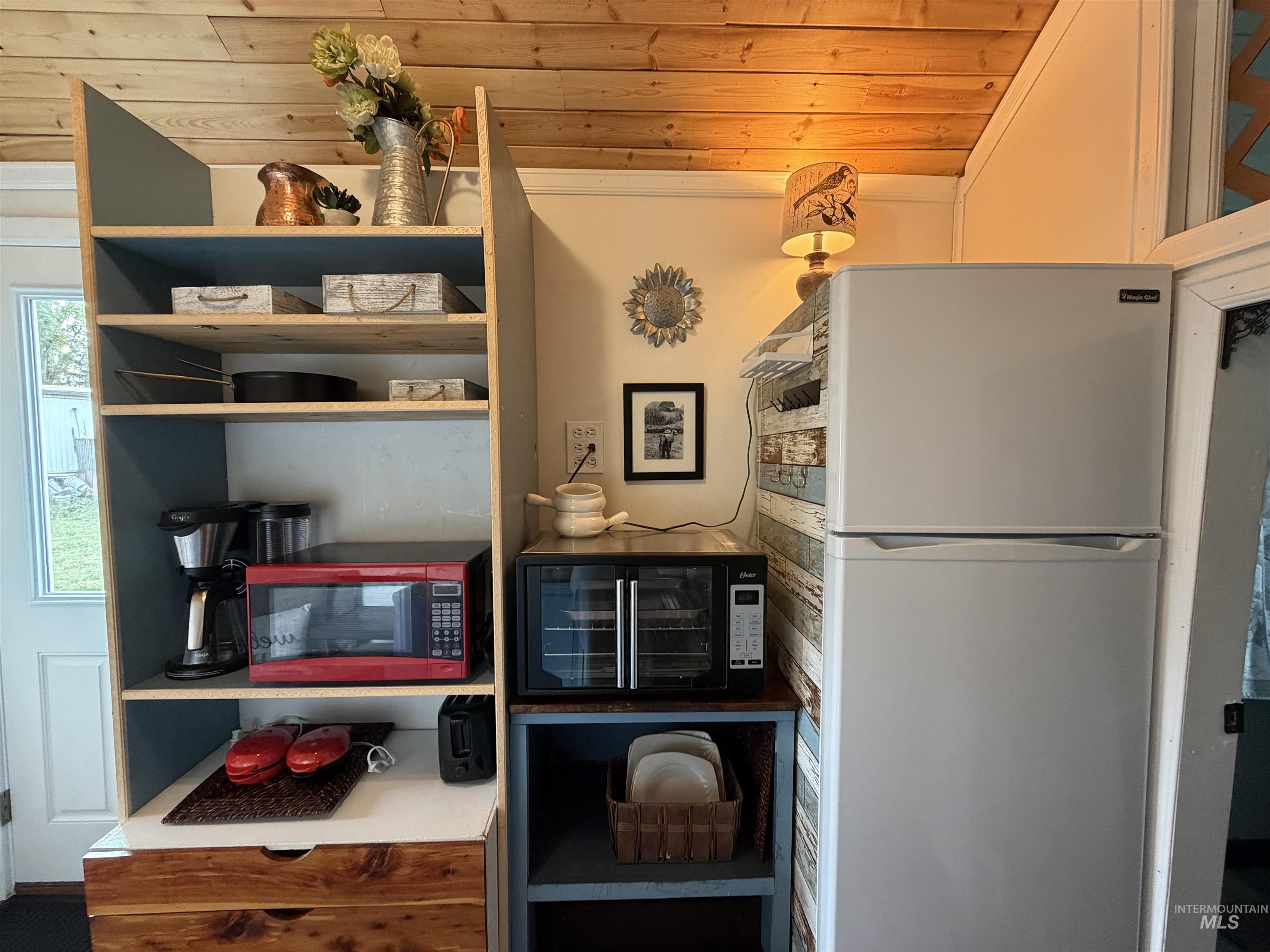 Kitchen featuring freestanding refrigerator and wood ceiling