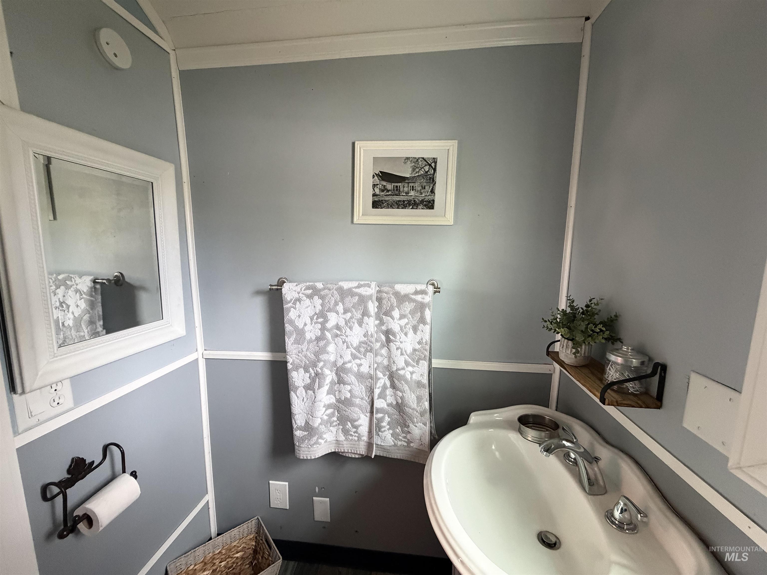 Bathroom with a sink and crown molding