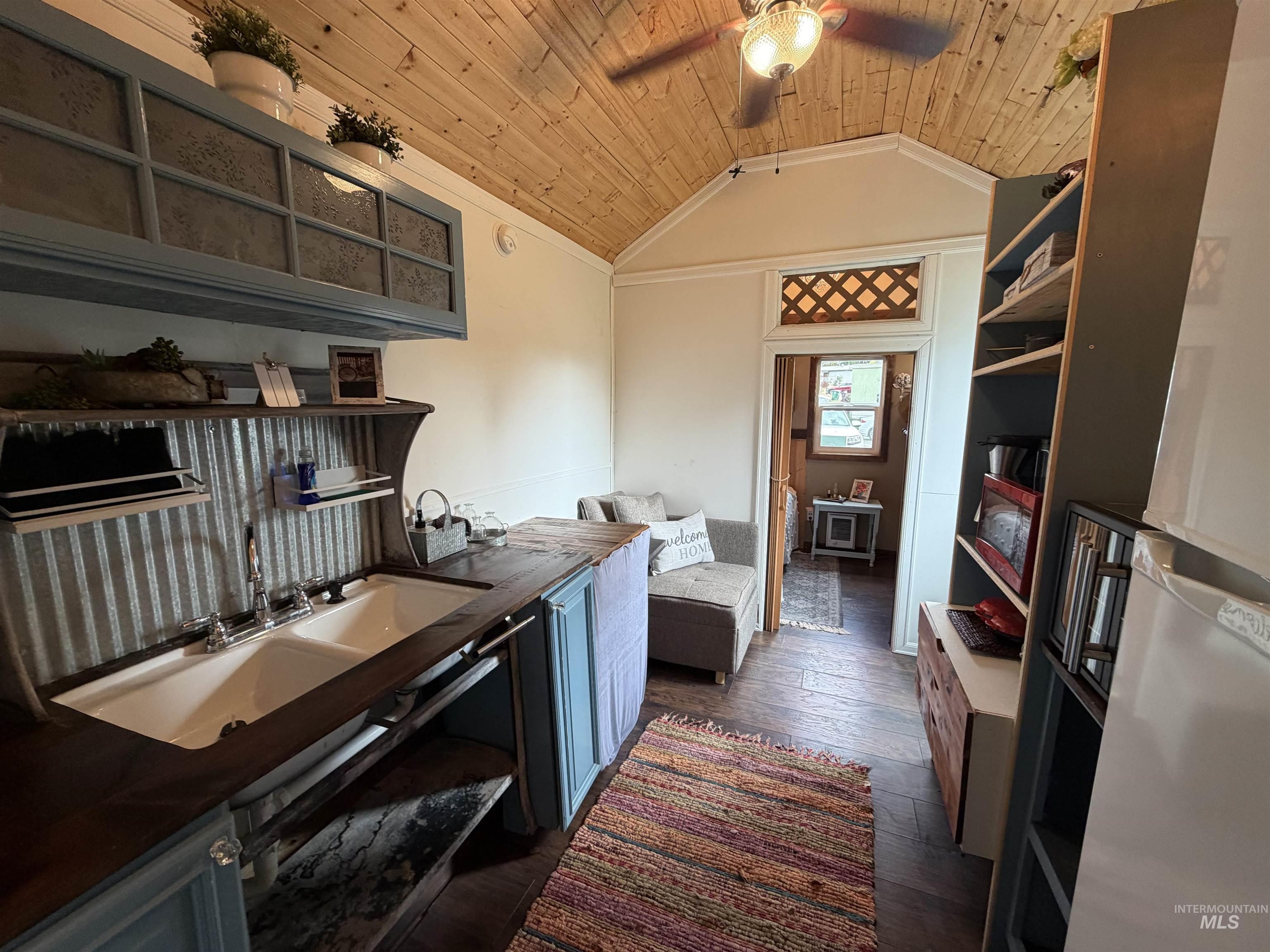 Kitchen featuring wooden ceiling, dark wood-style flooring, open shelves, lofted ceiling, and a ceiling fan