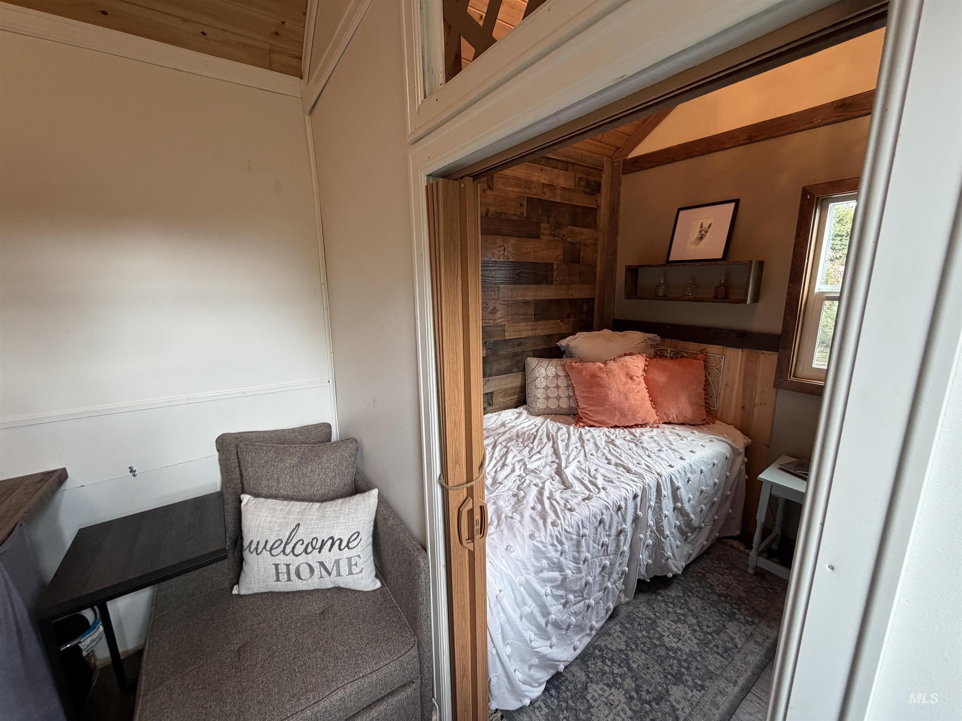 Bedroom with wood walls