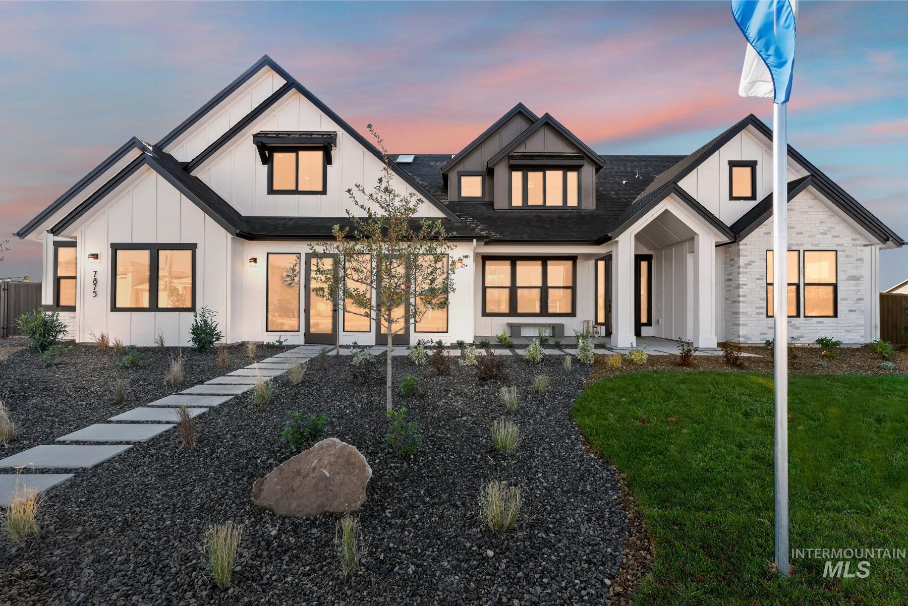 Modern farmhouse featuring board and batten siding and a shingled roof