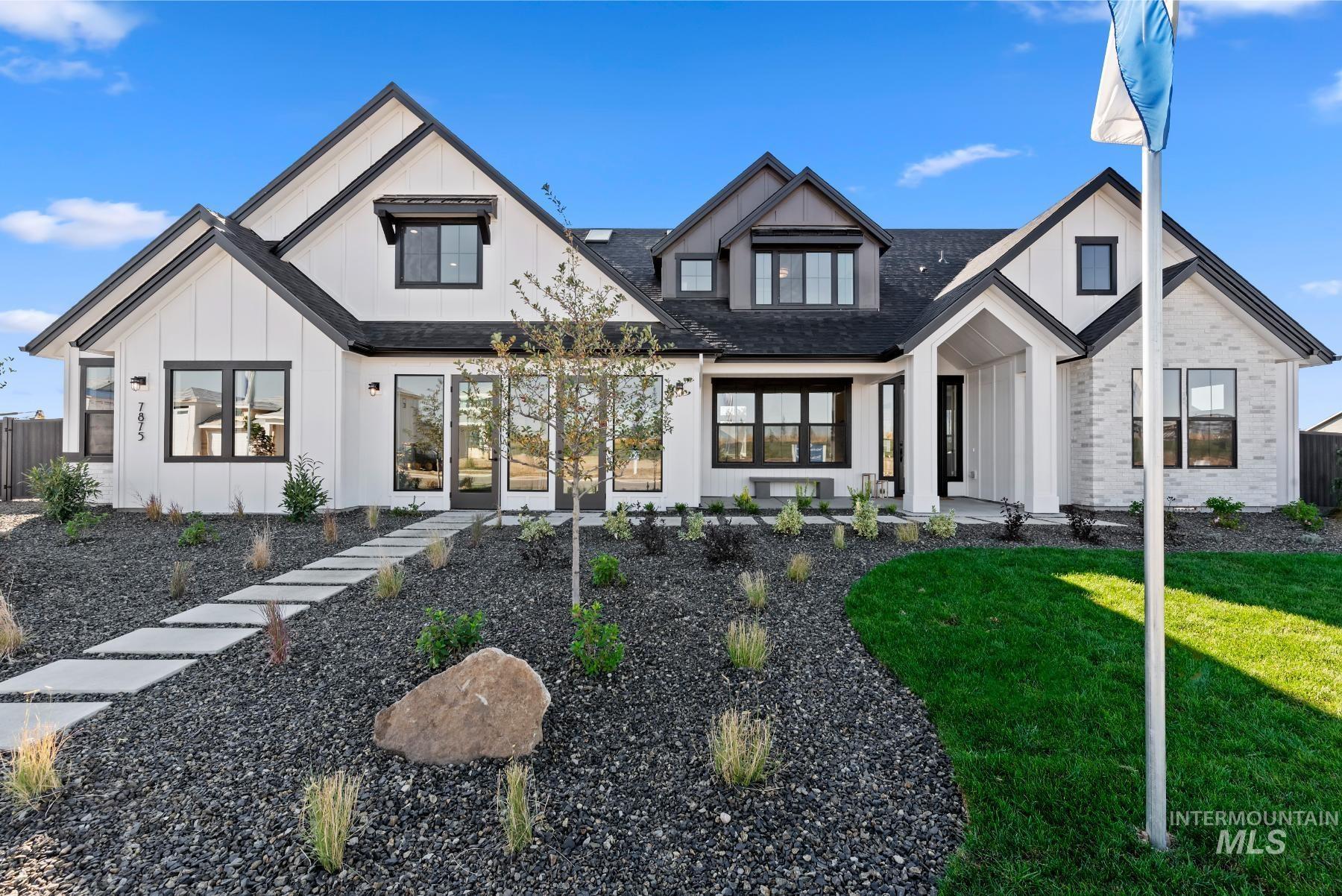 Modern farmhouse featuring board and batten siding and roof with shingles