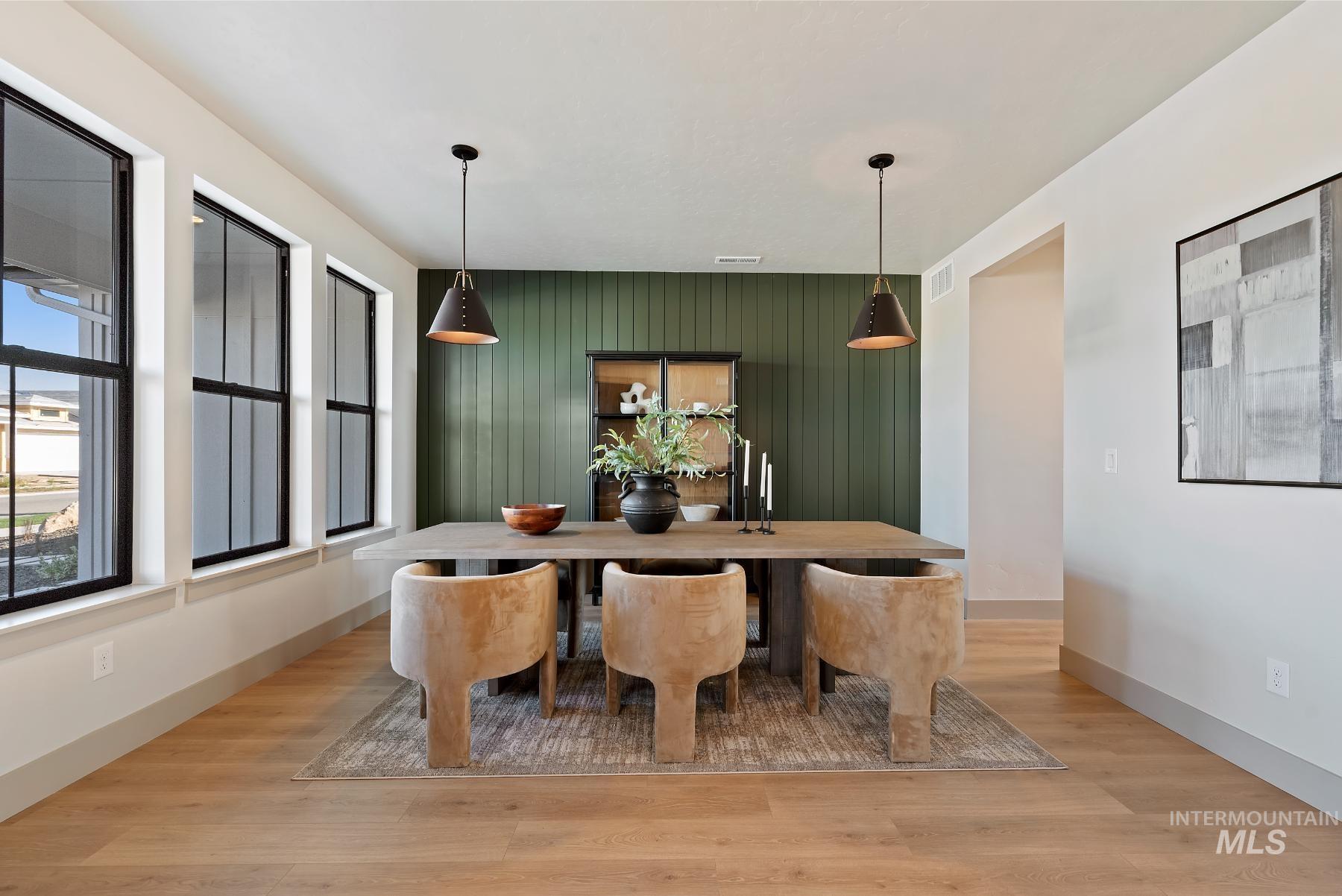Dining room with light wood-style flooring and baseboards
