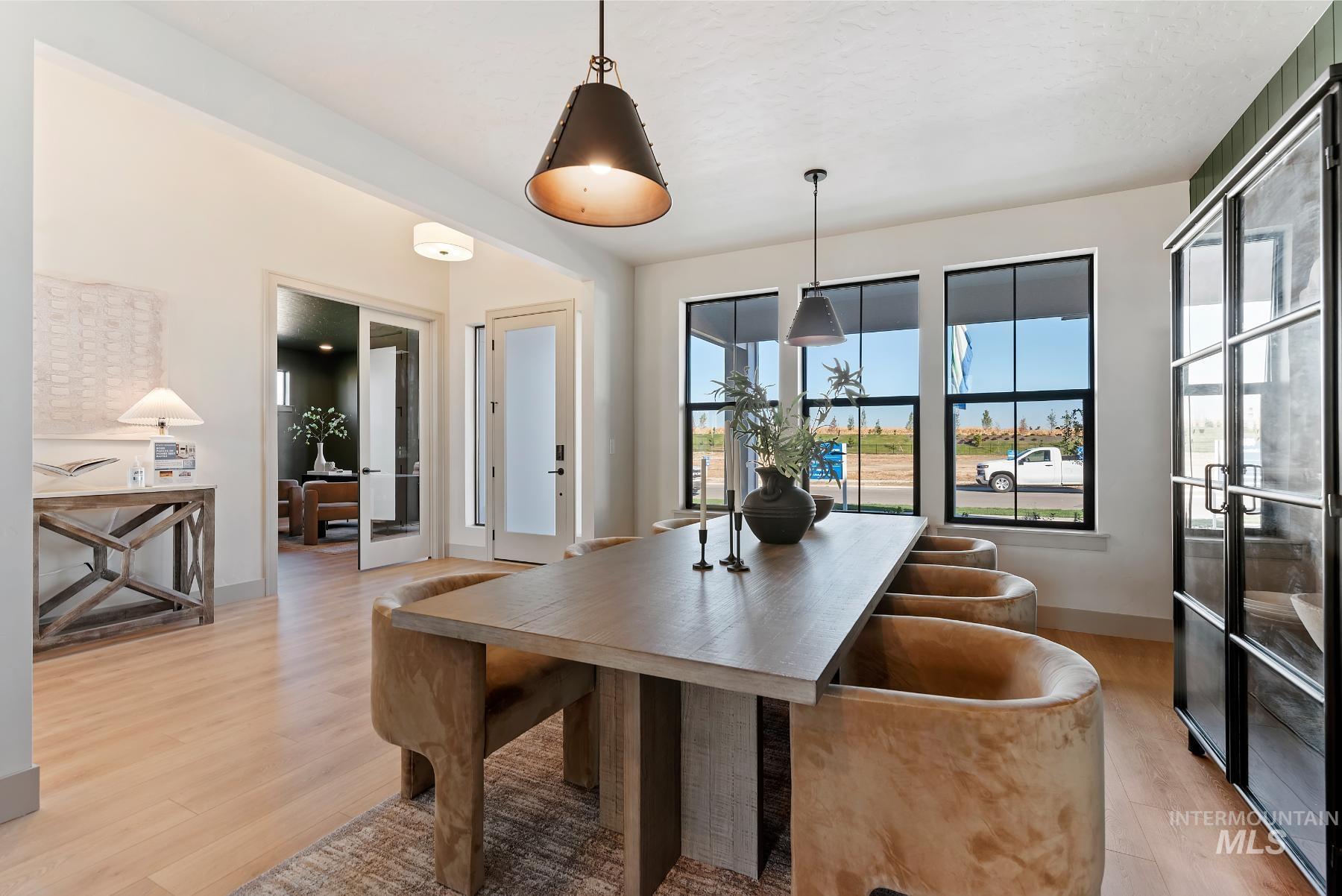 Dining room with light wood-type flooring and french doors