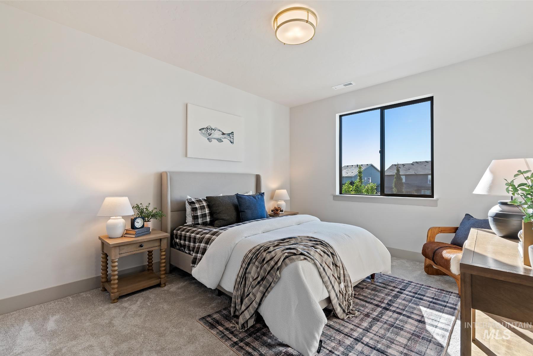 Bedroom featuring carpet floors and baseboards