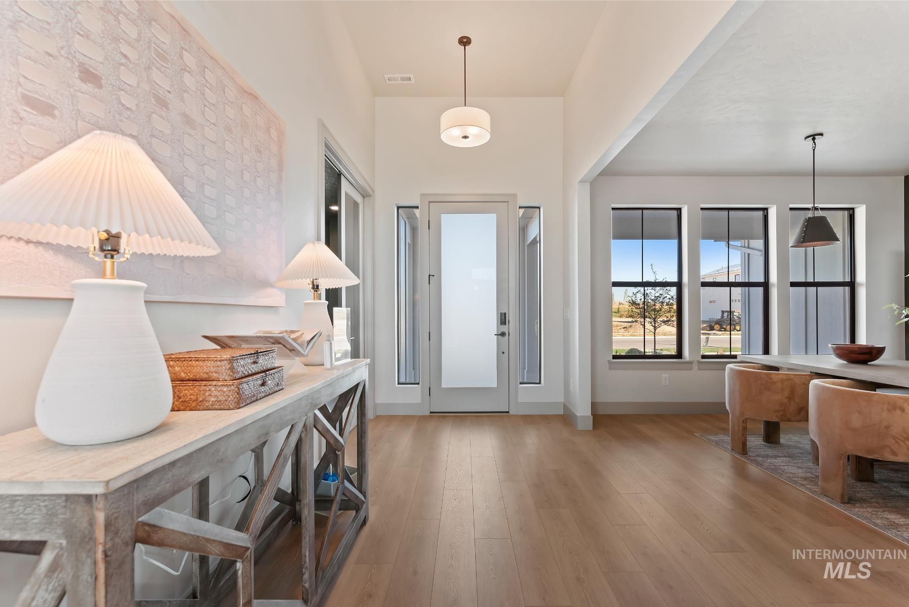 Foyer featuring light wood-style floors and baseboards