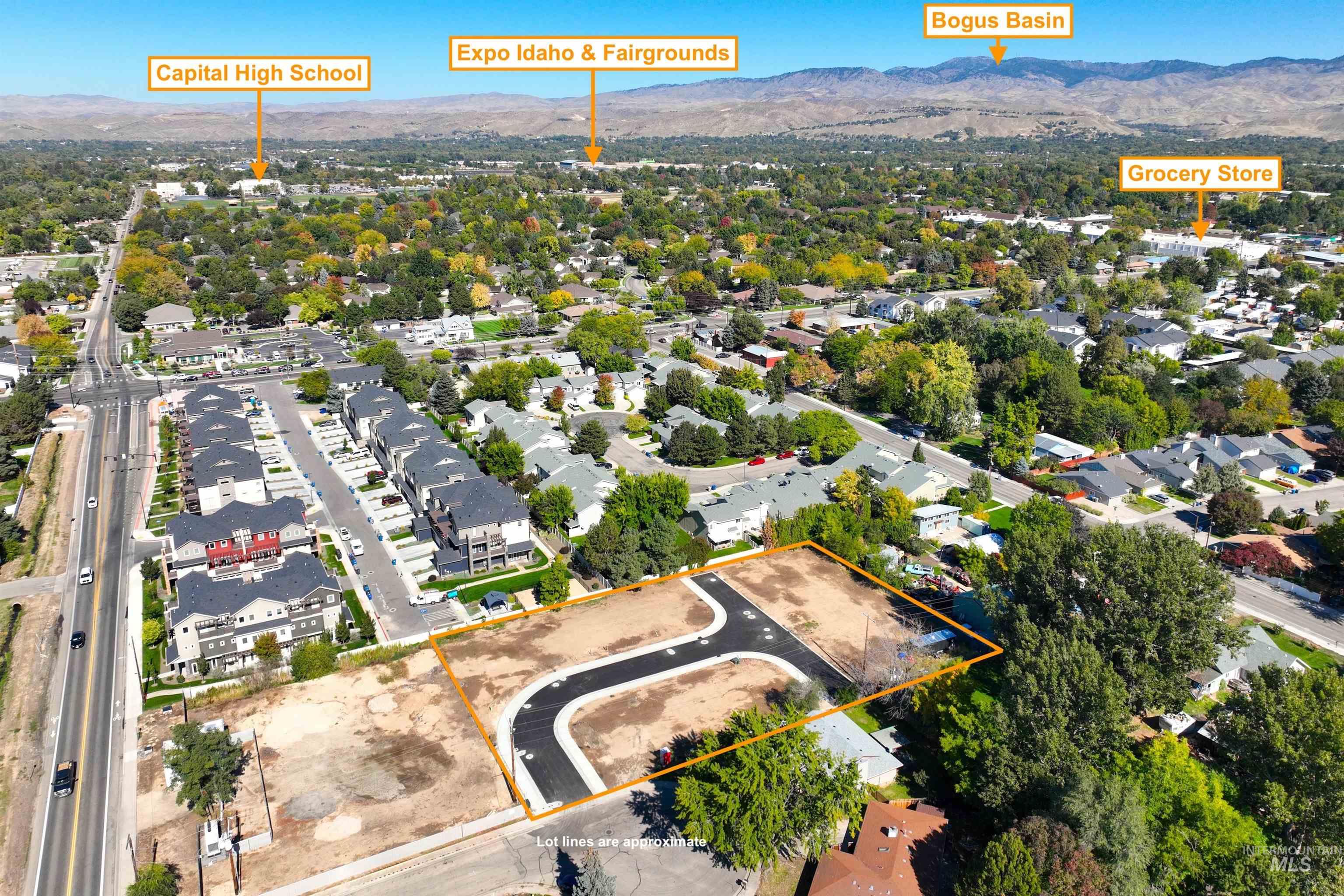 Aerial view of residential area with a mountain backdrop and property parcel outlined