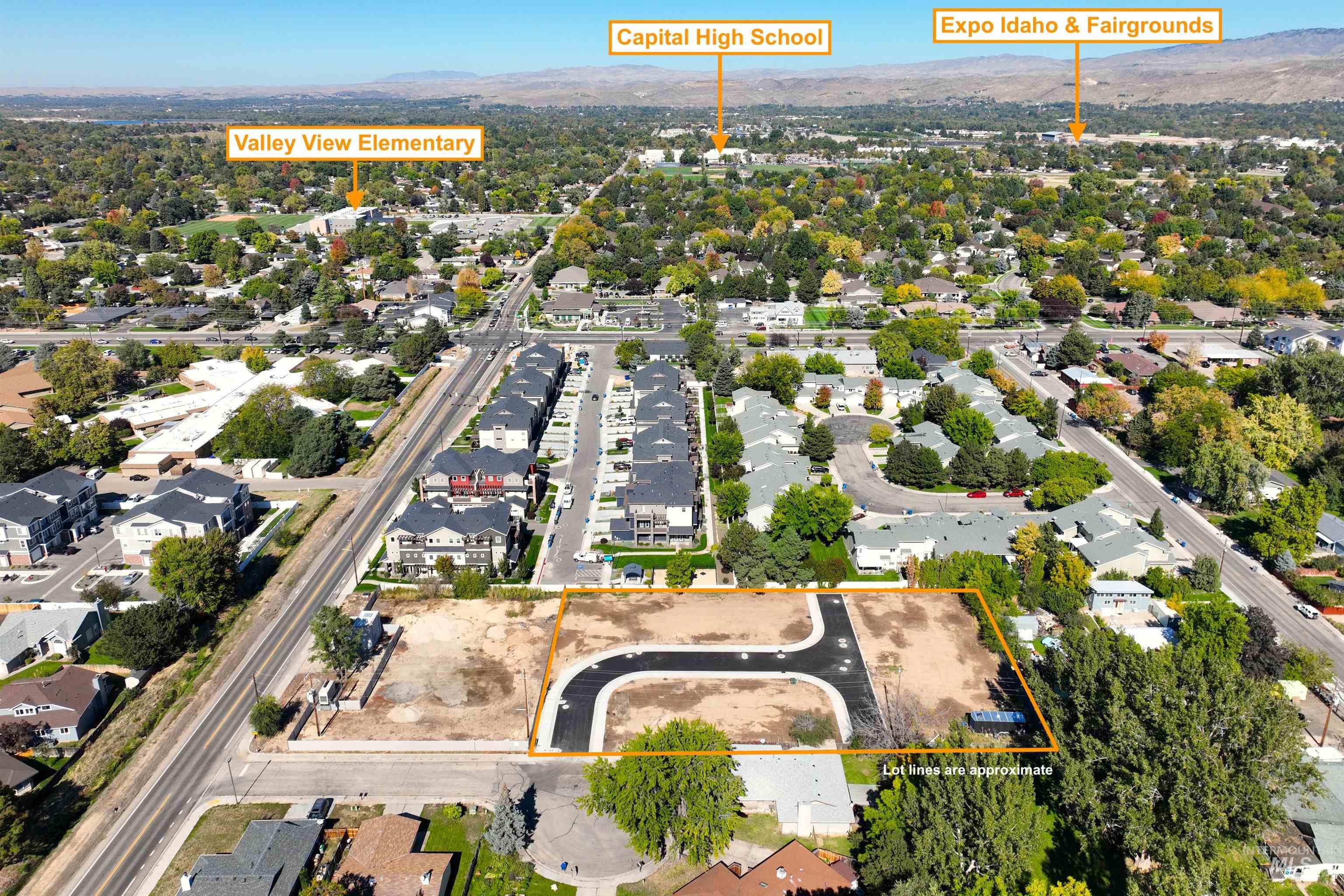 Aerial perspective of suburban area with property parcel outlined and a mountain backdrop
