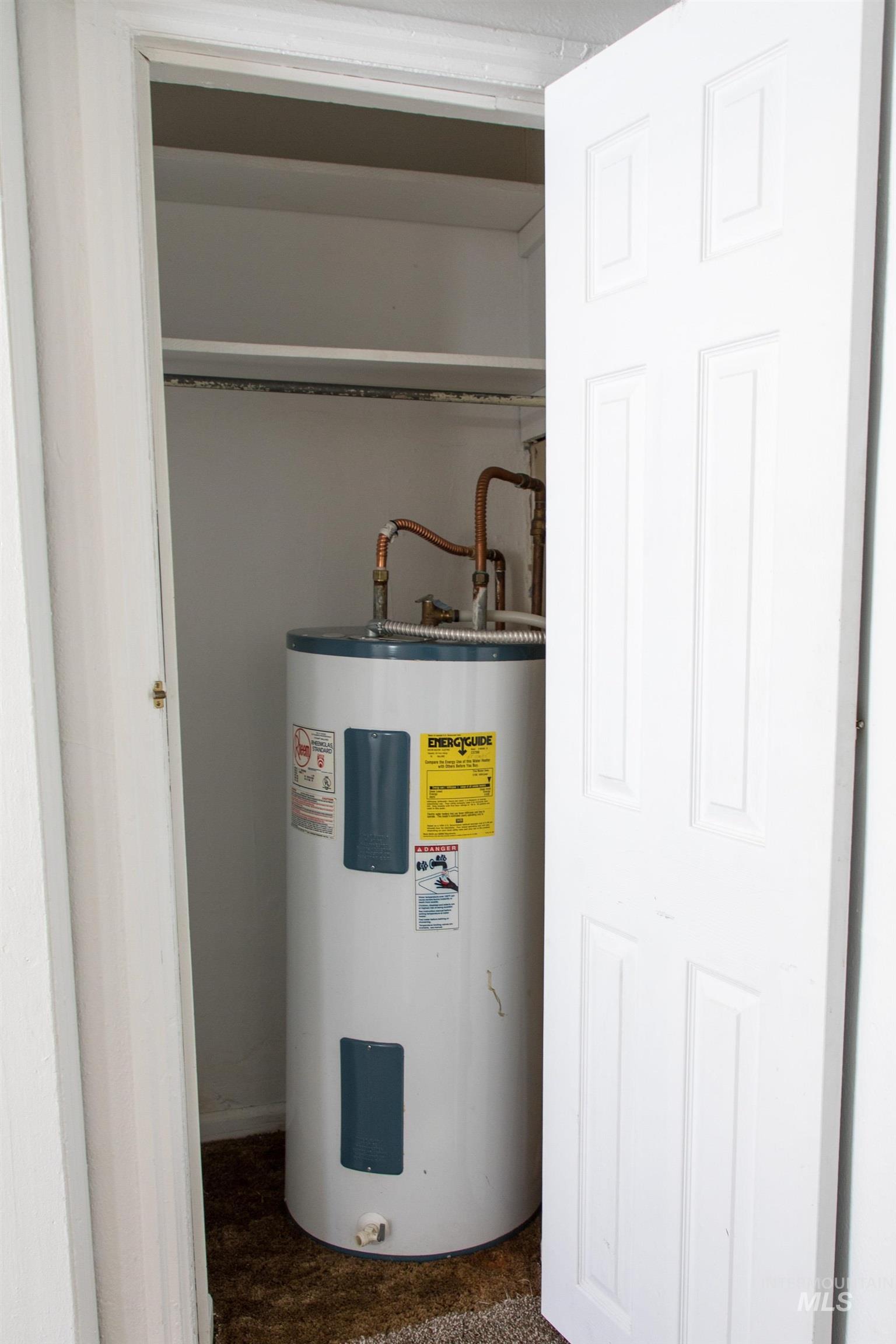 Utility room featuring electric water heater