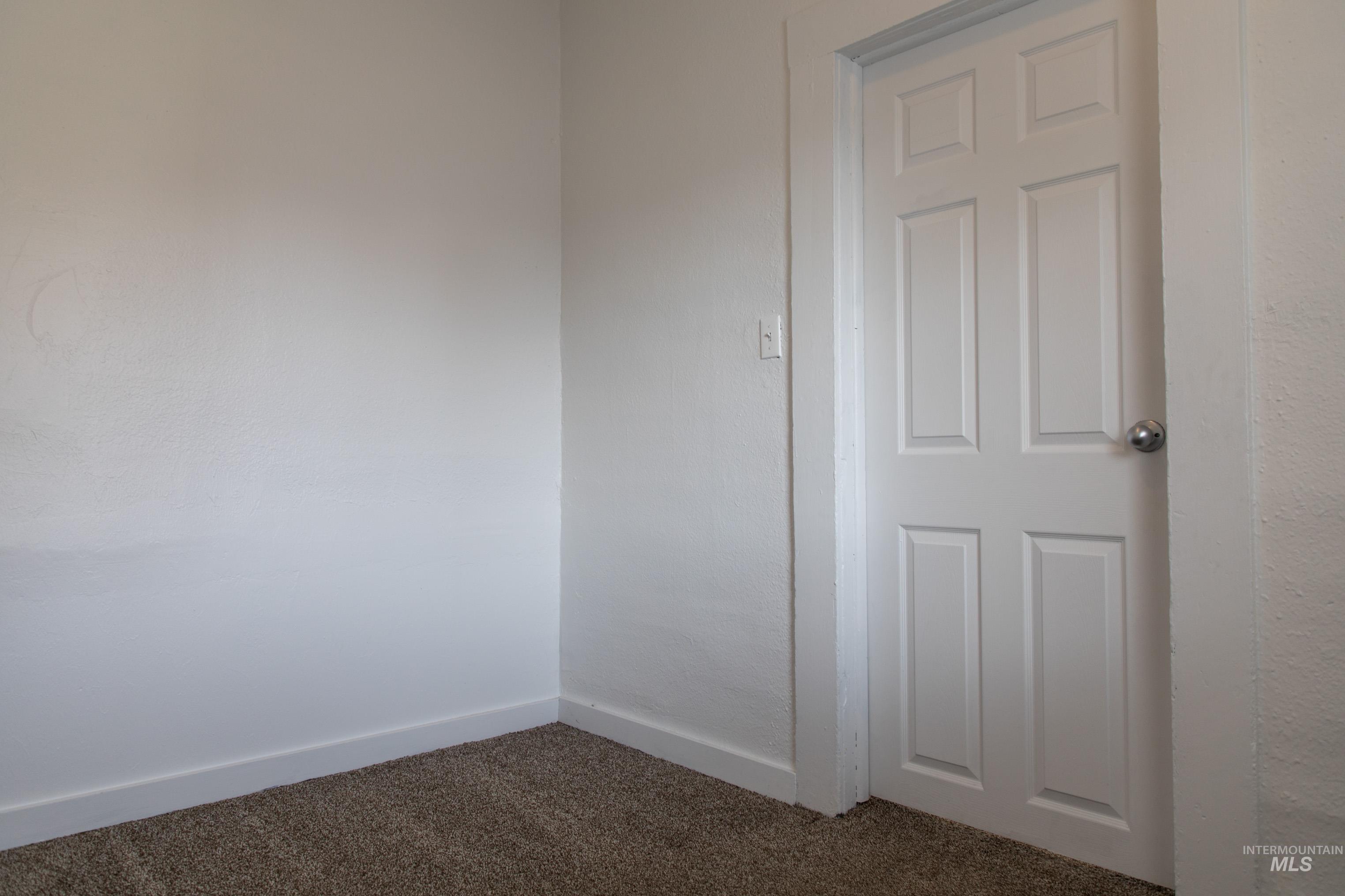 Spare room with carpet floors and baseboards