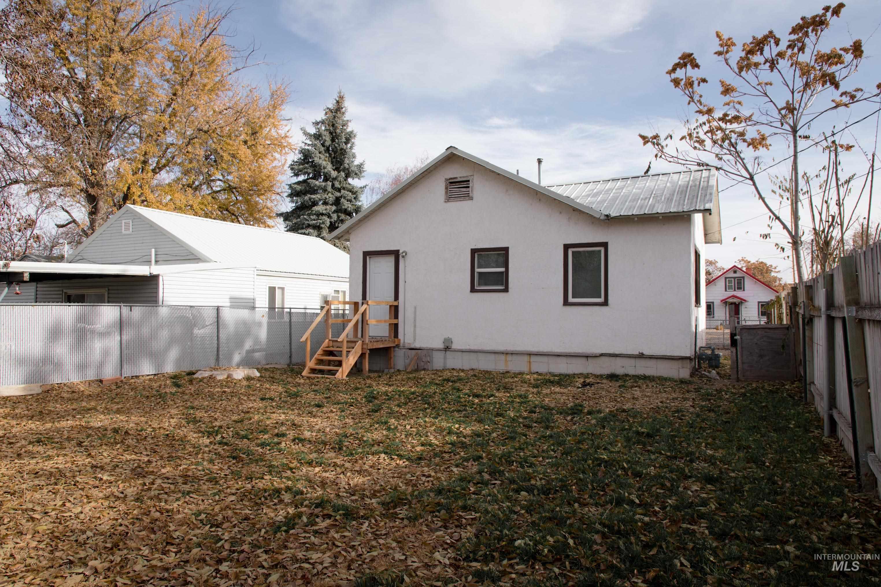 Rear view of property with a fenced backyard and a metal roof