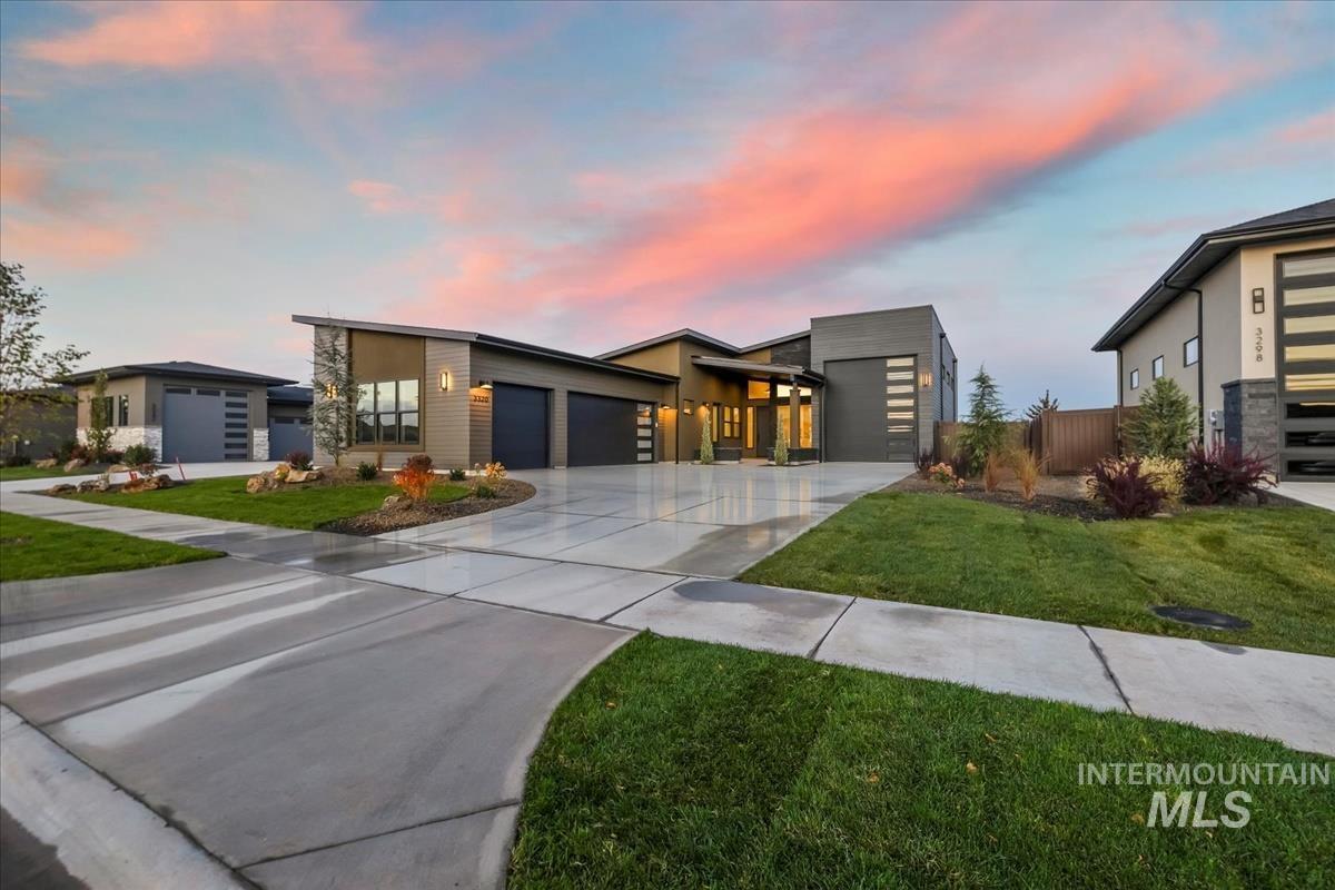 Modern, custom designed home with driveway, a yard, and a 3-car garage plus an RV garage