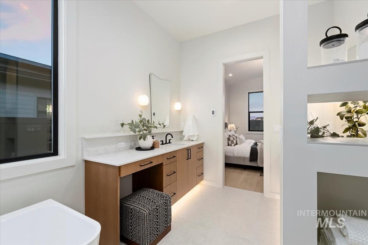 Ensuite bathroom with vanity and a freestanding bath