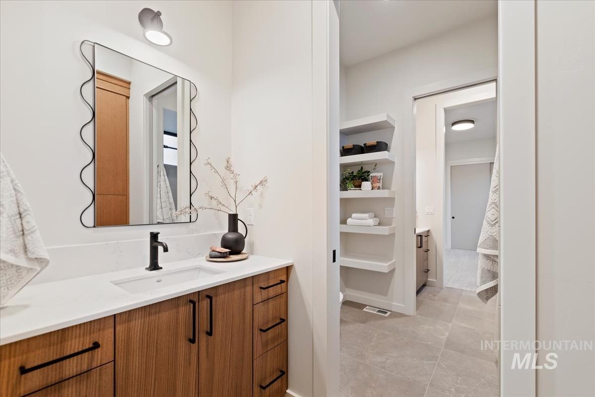 Bathroom with vanity and light tile patterned floors