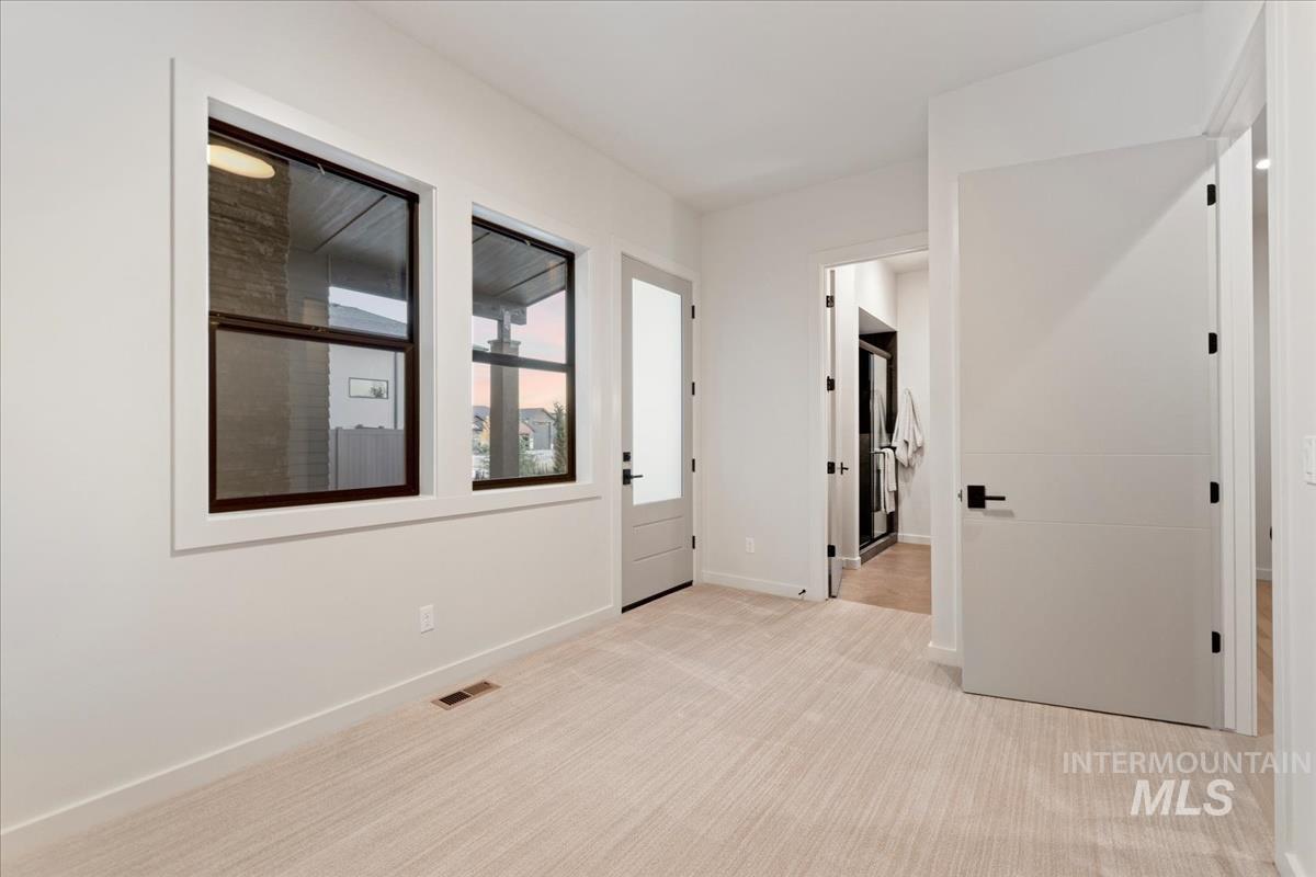 Mother-in-law suite or flex room featuring light colored carpet and baseboards