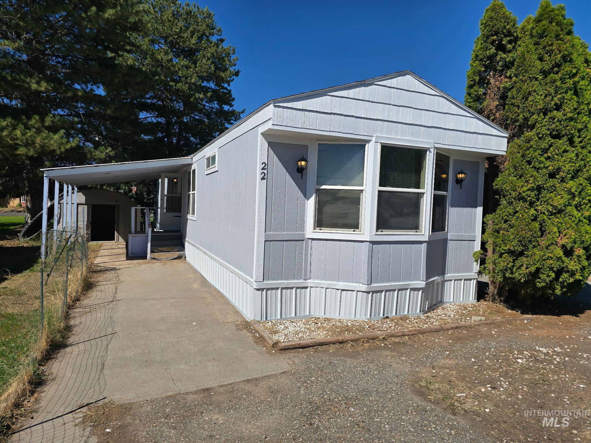 View of front of home with an attached carport and a porch