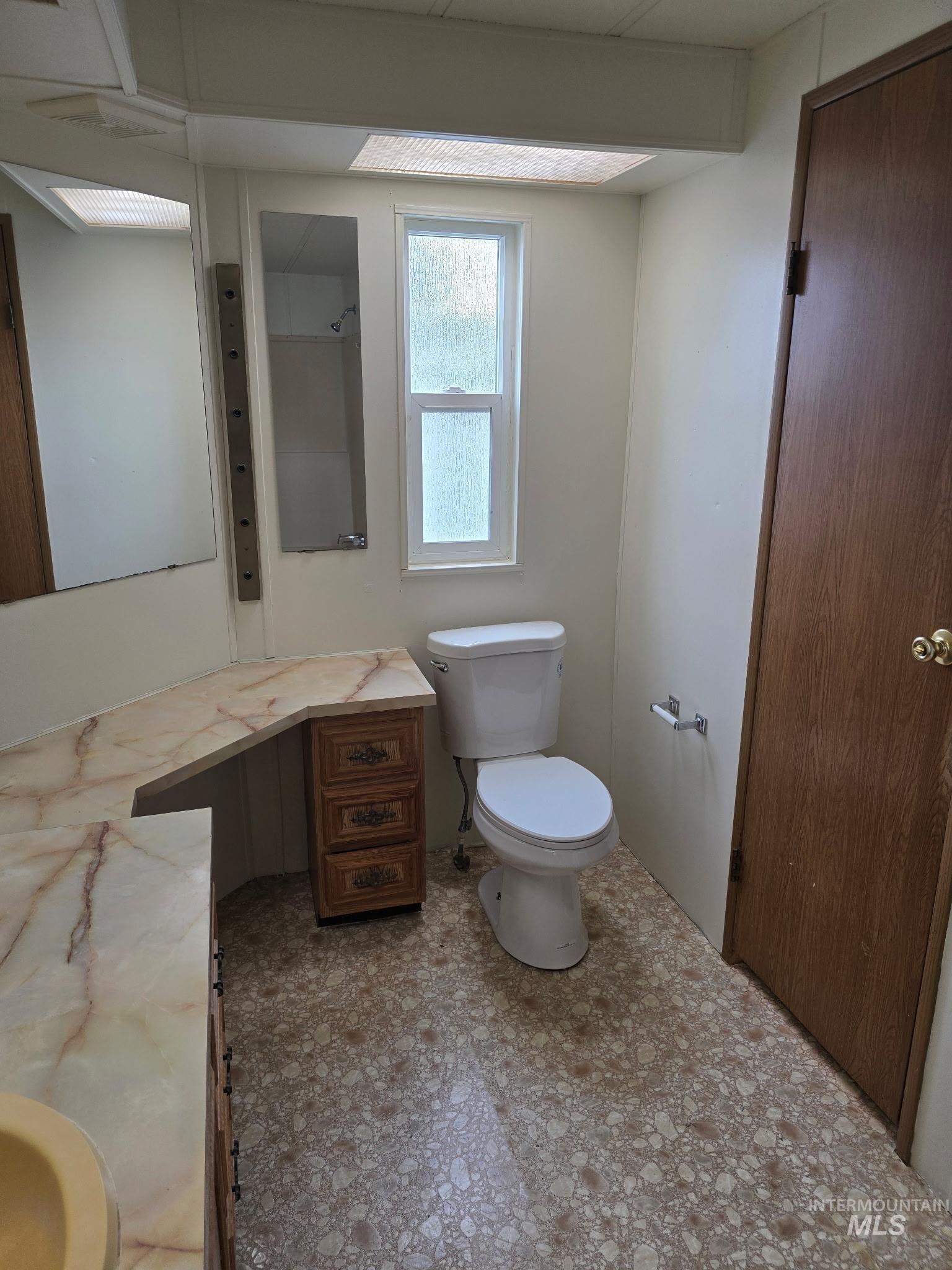 Full bathroom featuring vanity and toilet