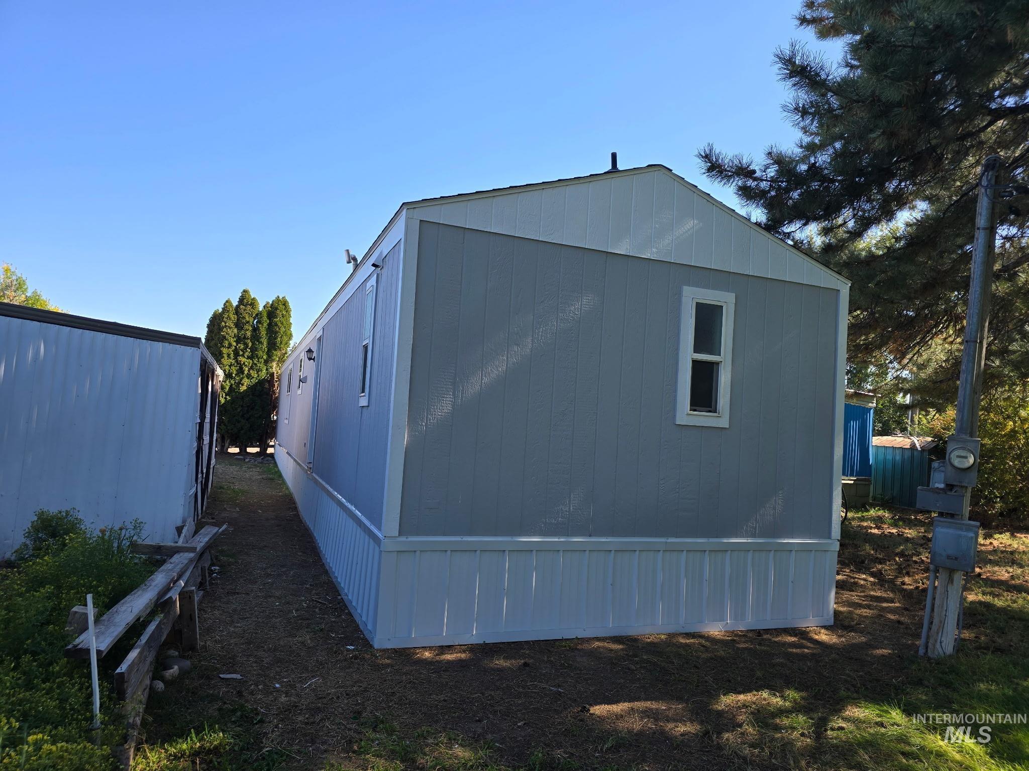 View of side of home with an outbuilding