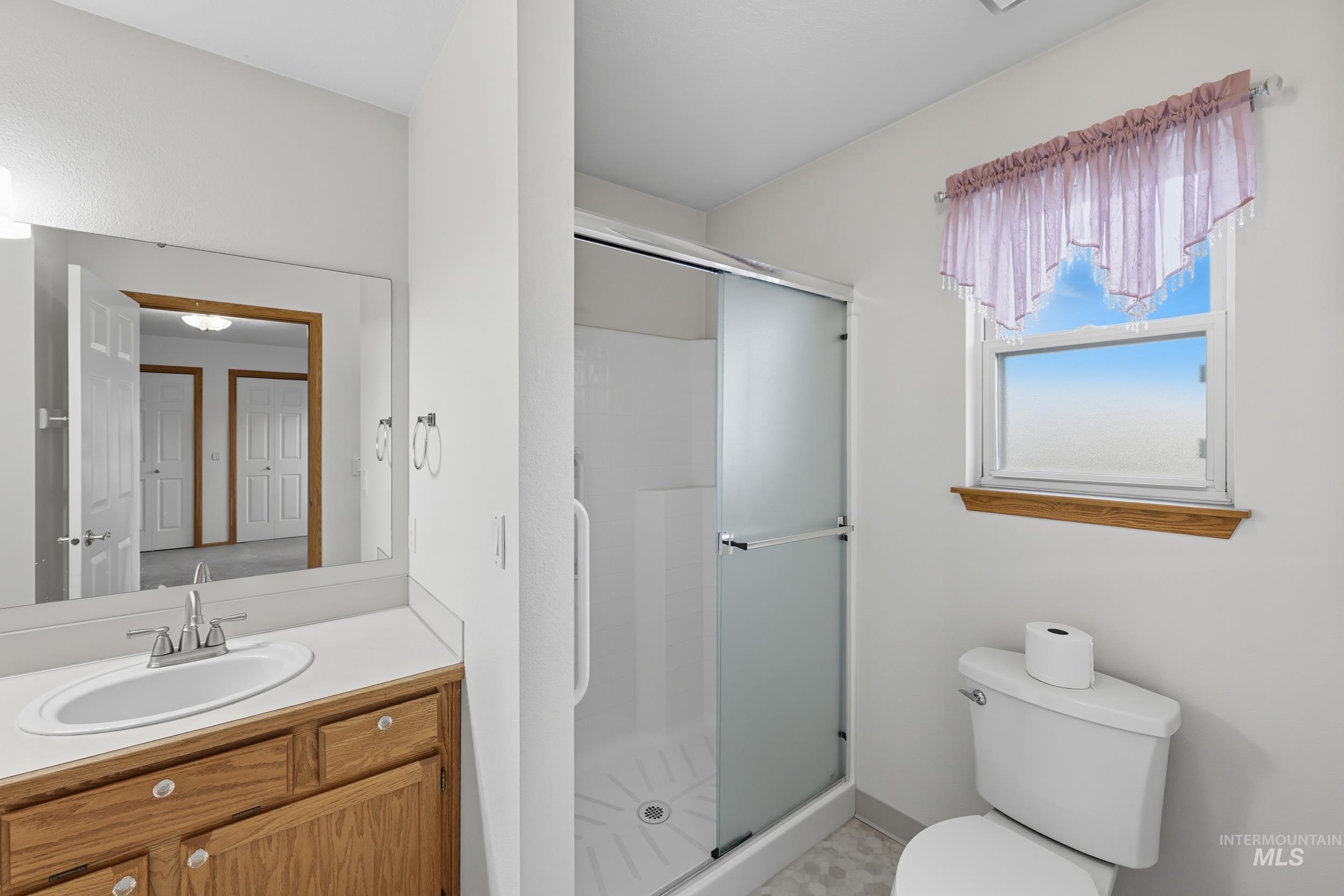 Bathroom with a shower stall and vanity