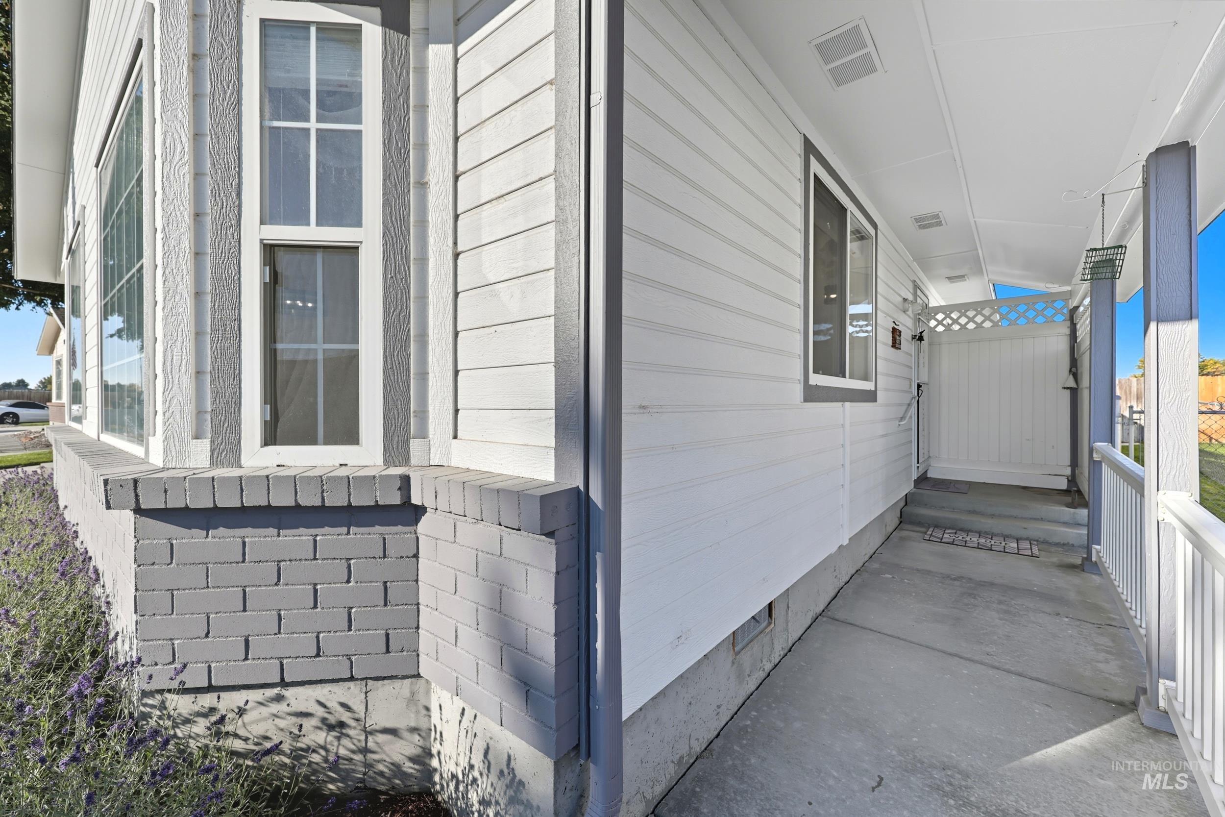 View of side of property featuring crawl space and covered porch