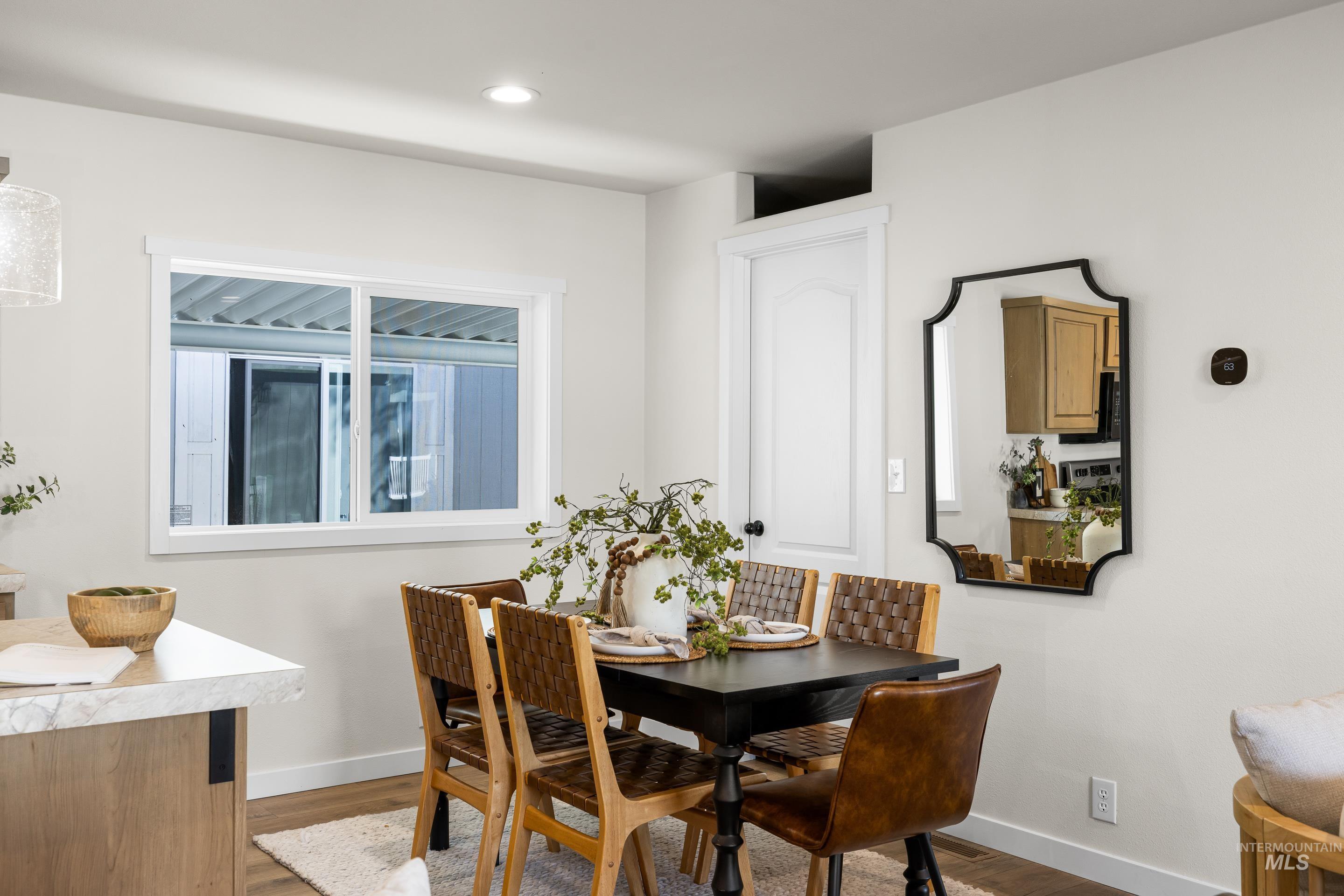 Dining space featuring dark wood-type flooring and recessed lighting