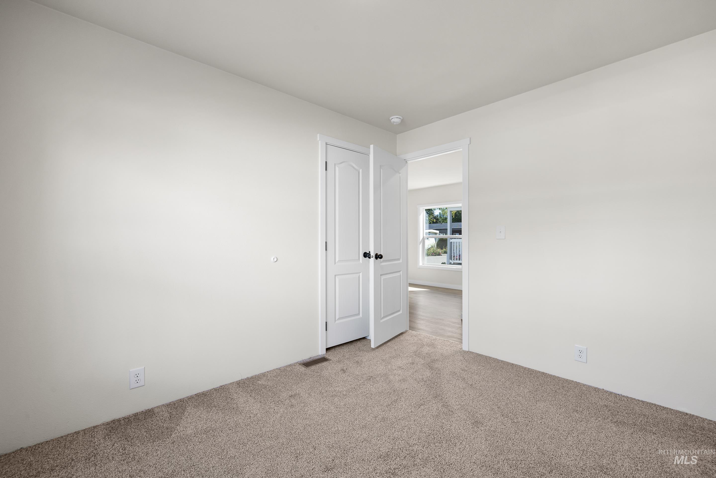 Unfurnished room with carpet floors