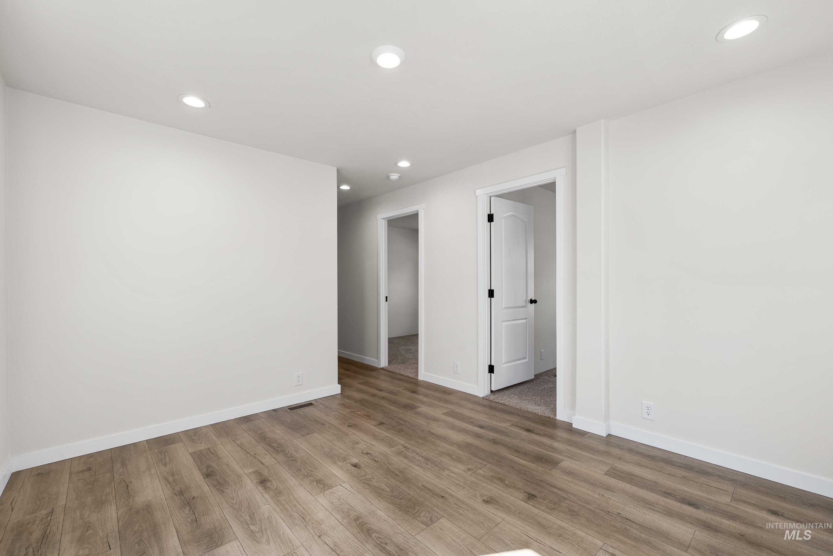 Unfurnished room with recessed lighting and light wood-type flooring