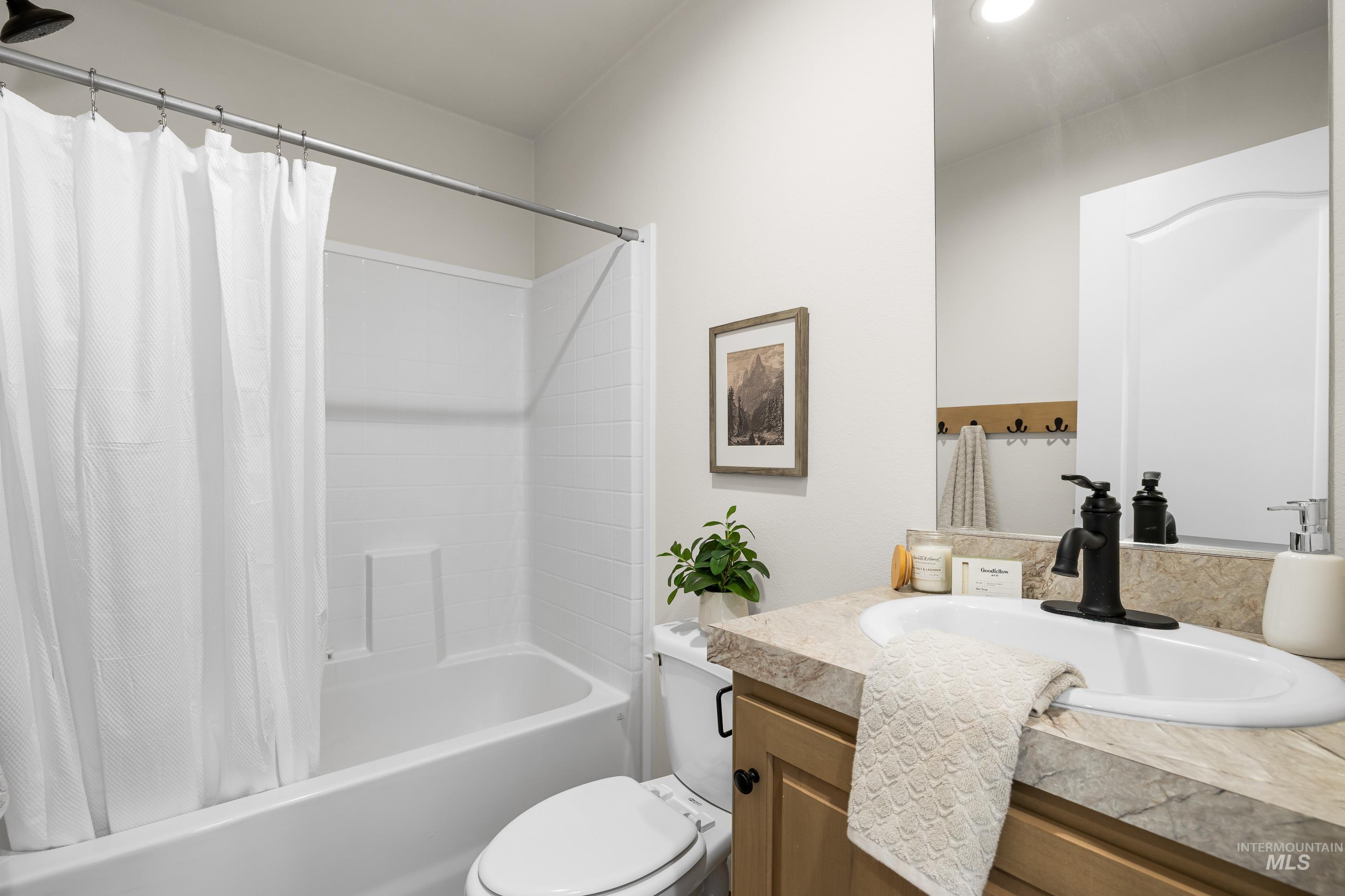 Bathroom featuring shower / tub combo and vanity
