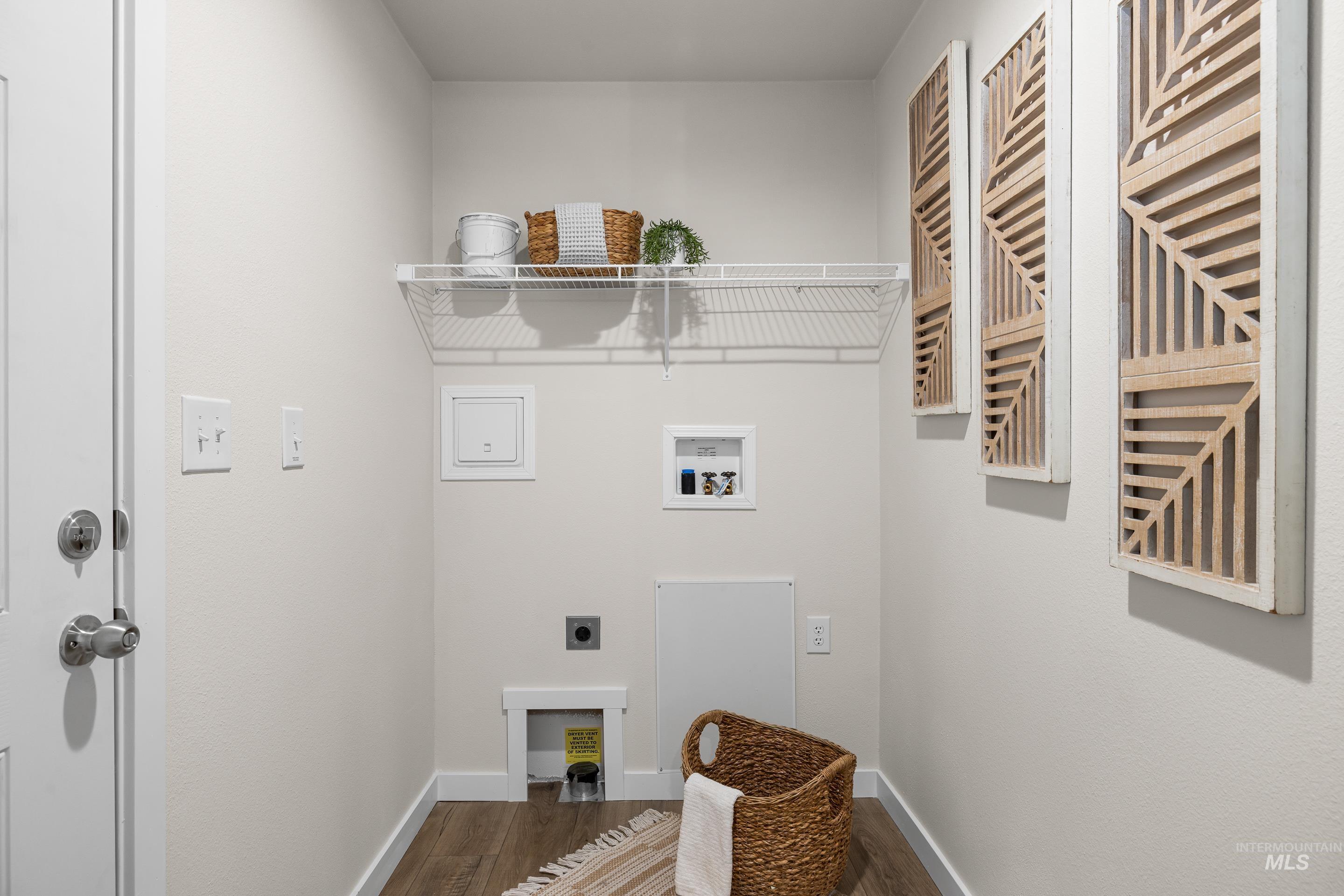 Laundry room with dark wood finished floors, electric dryer hookup, and washer hookup