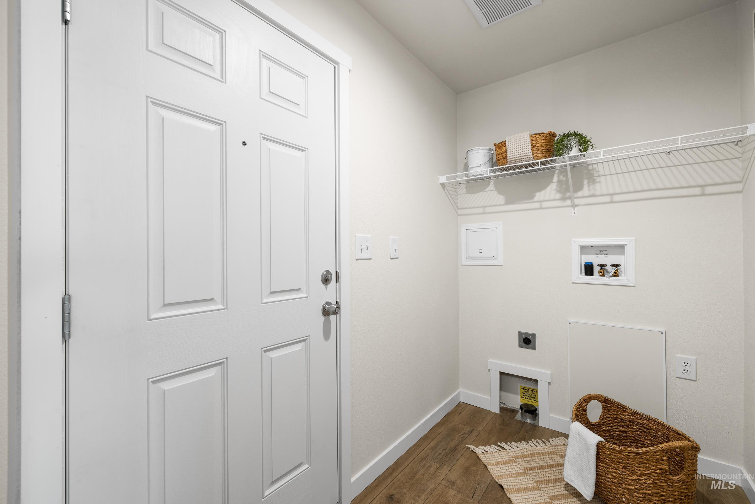Laundry room with dark wood-style flooring, electric dryer hookup, and hookup for a washing machine