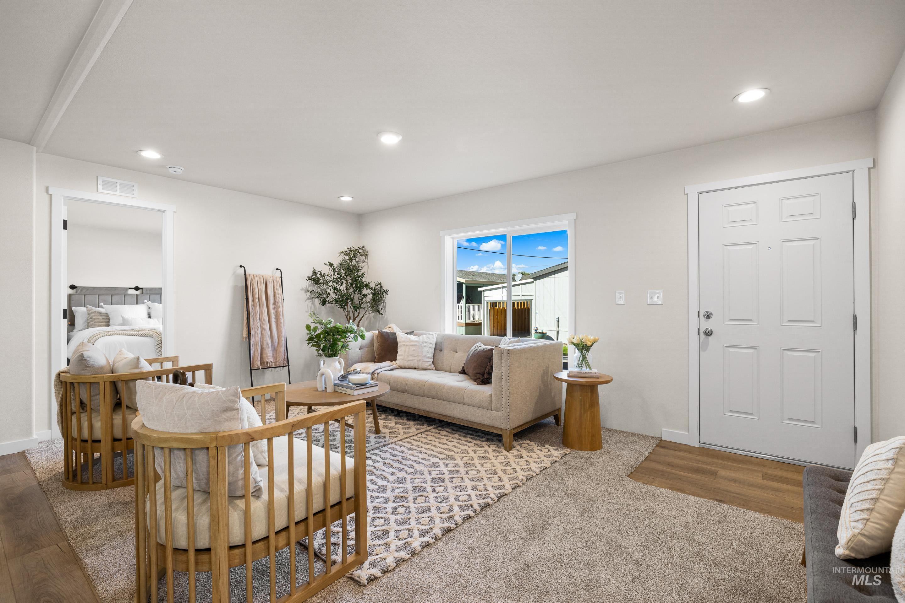 Living area featuring recessed lighting, wood finished floors, and carpet
