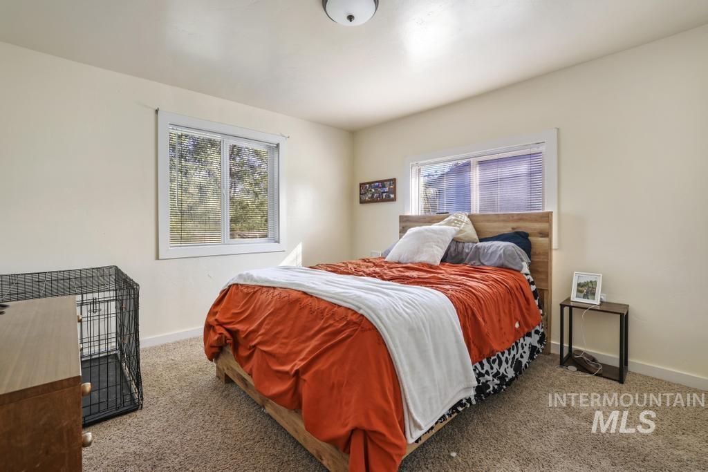Carpeted bedroom featuring baseboards