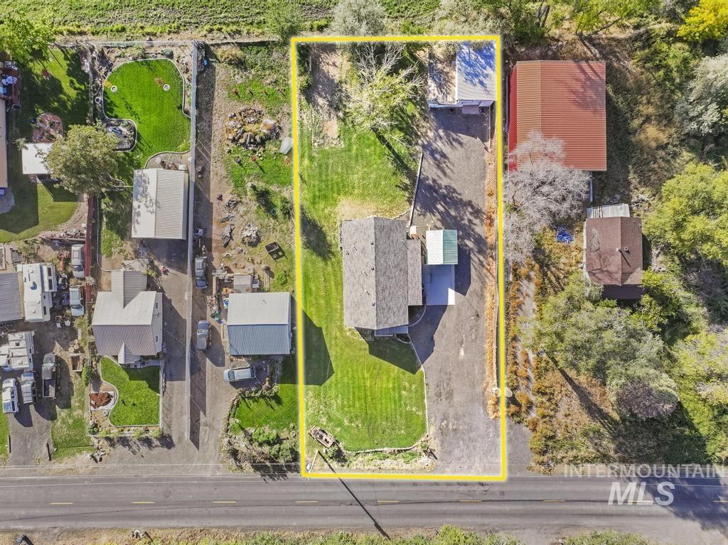 Aerial view of property and surrounding area with property parcel outlined