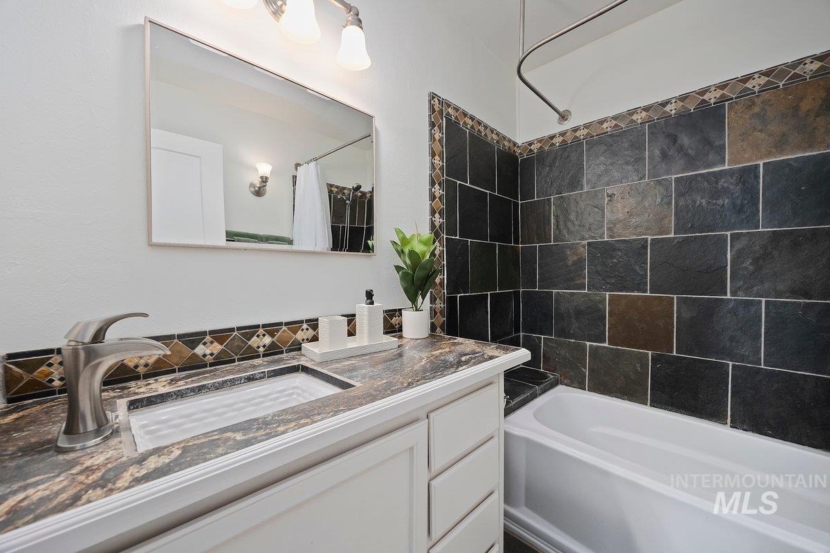 Bathroom featuring shower / tub combo and vanity