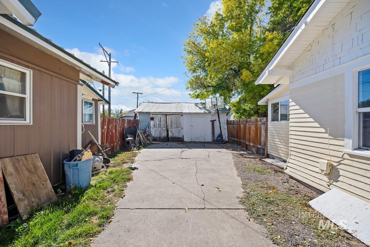 Fenced backyard featuring a storage shed