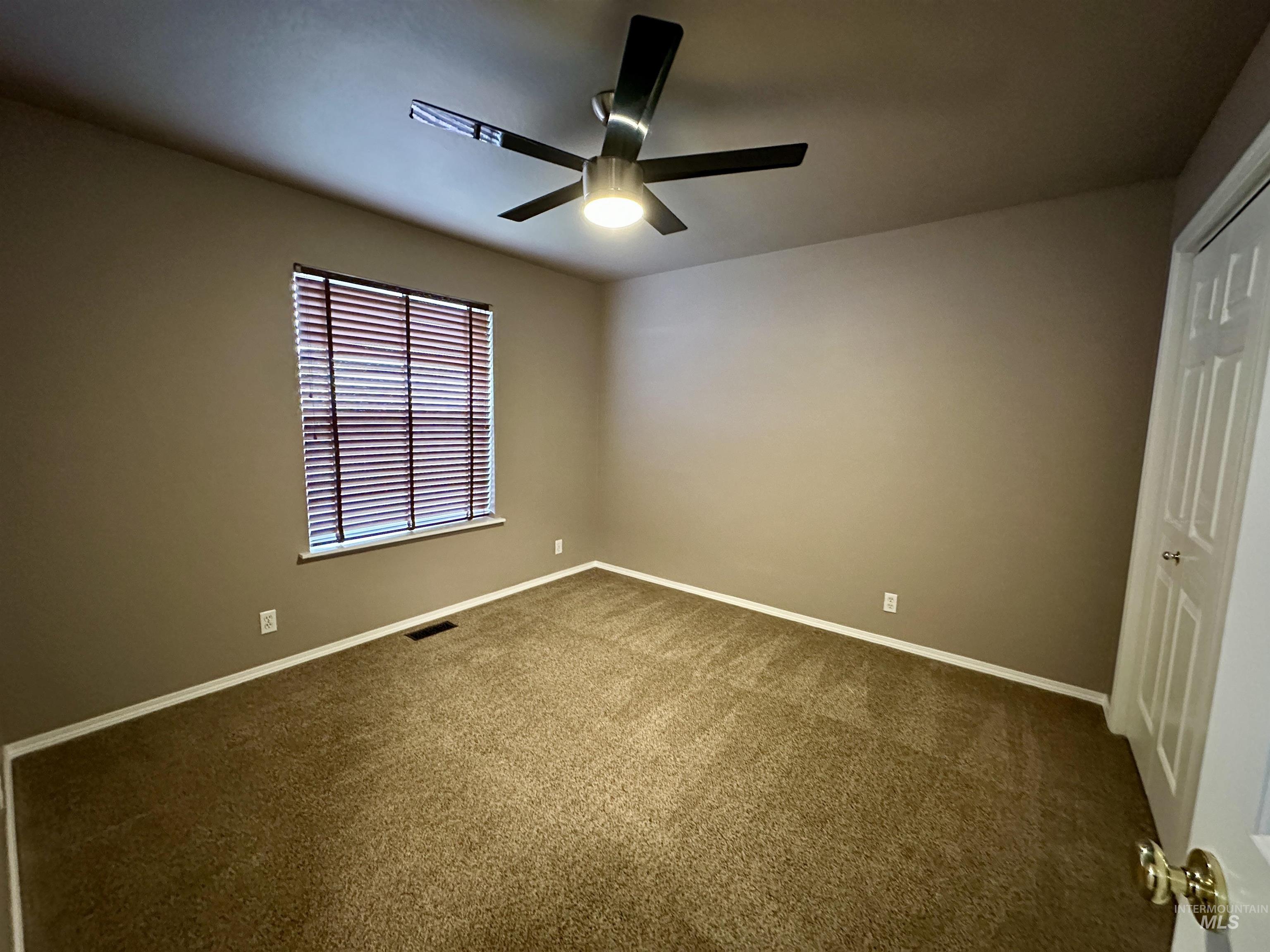 Unfurnished bedroom with a closet, carpet, and ceiling fan