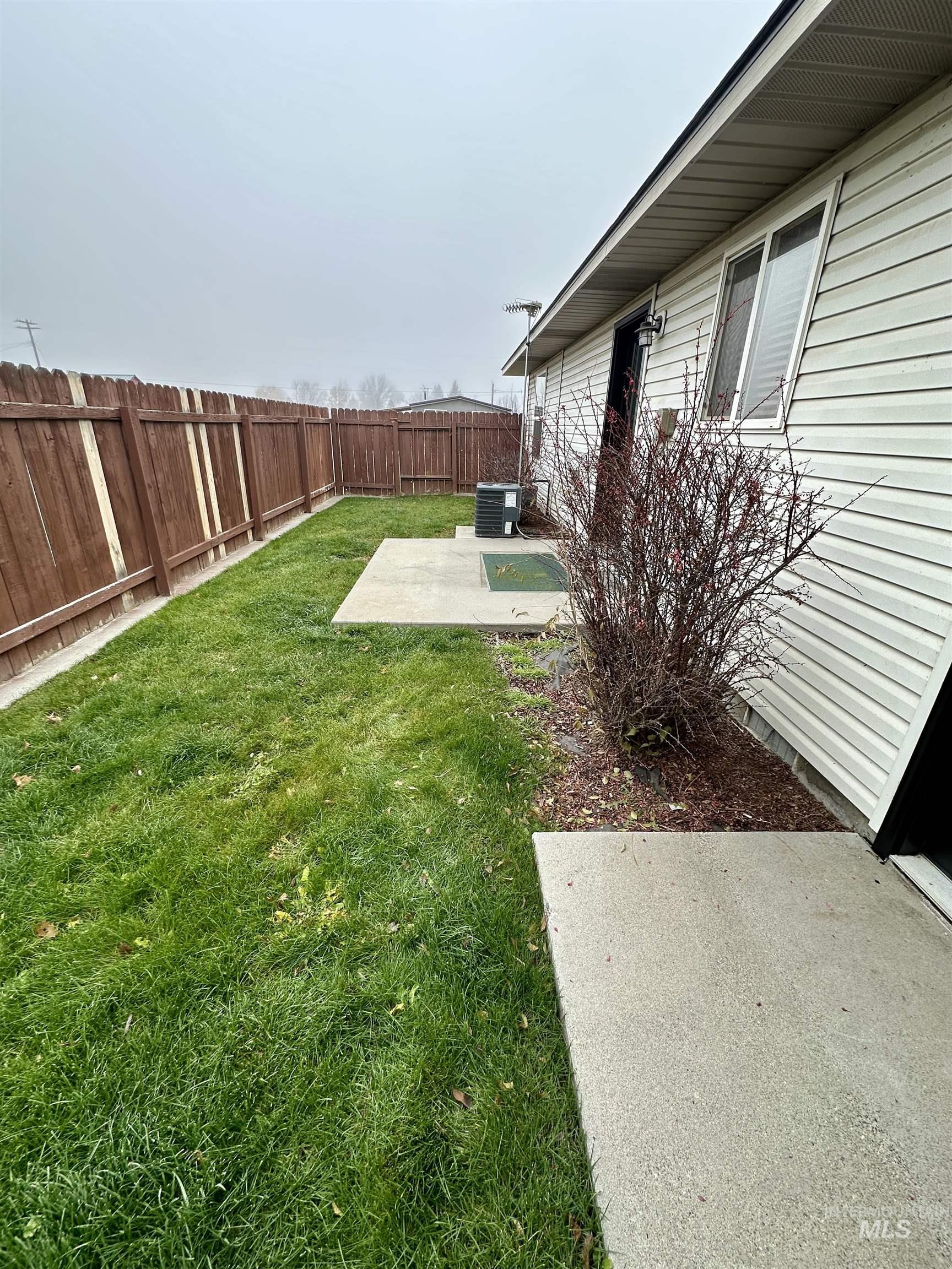 Fenced backyard with a patio