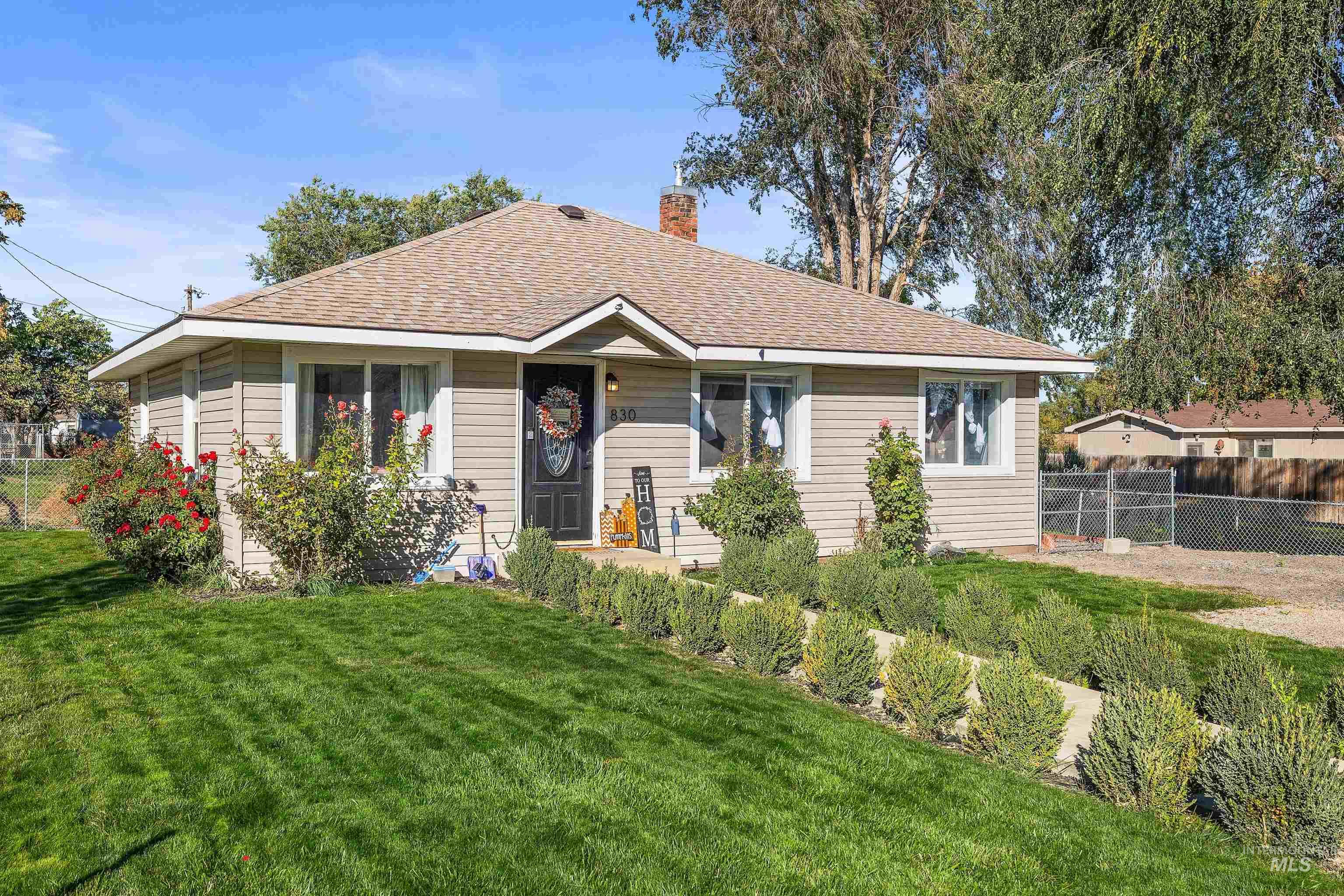 Bungalow-style home with roof with shingles and a chimney