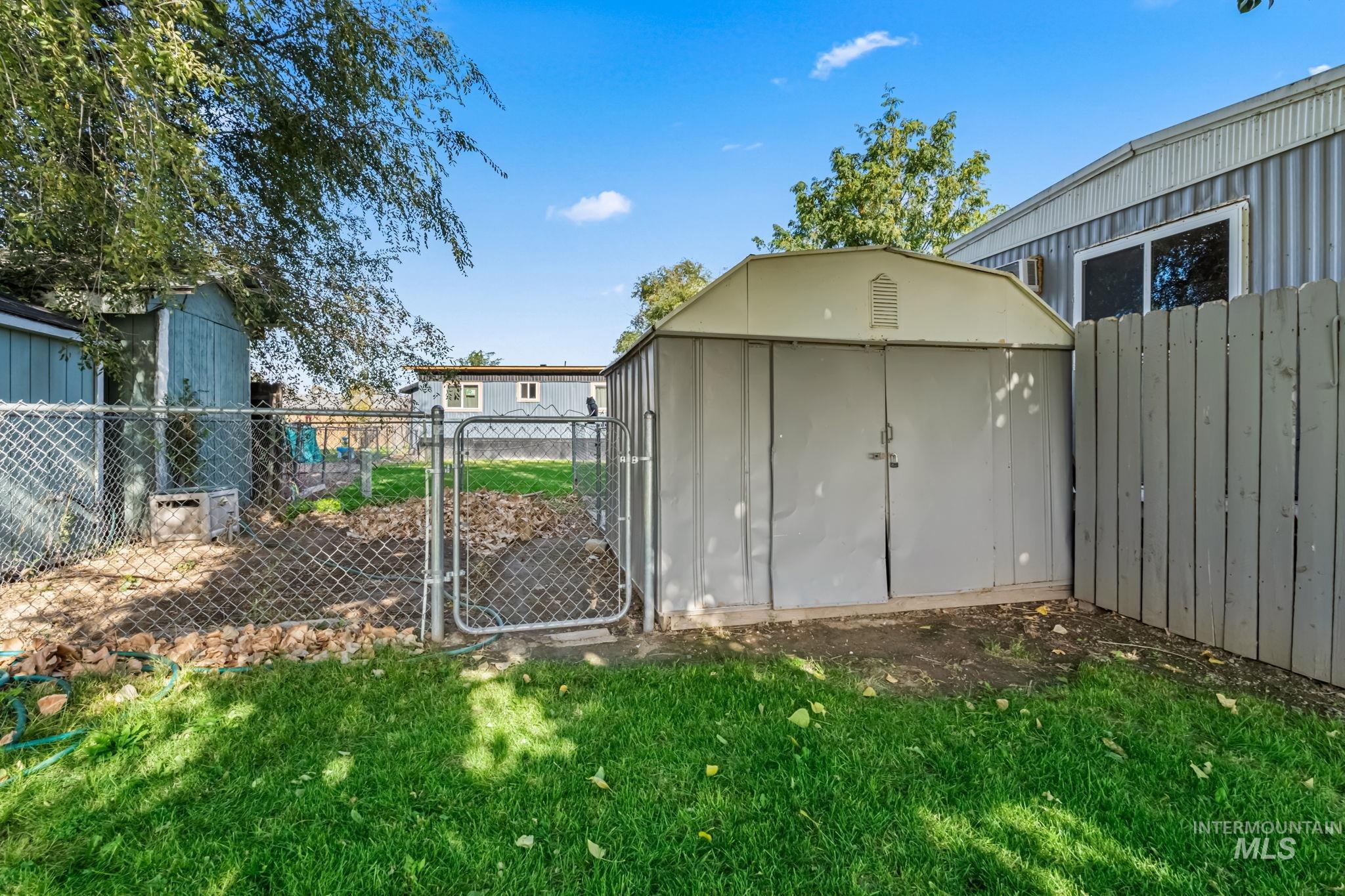 View of shed with a gate and a fenced backyard