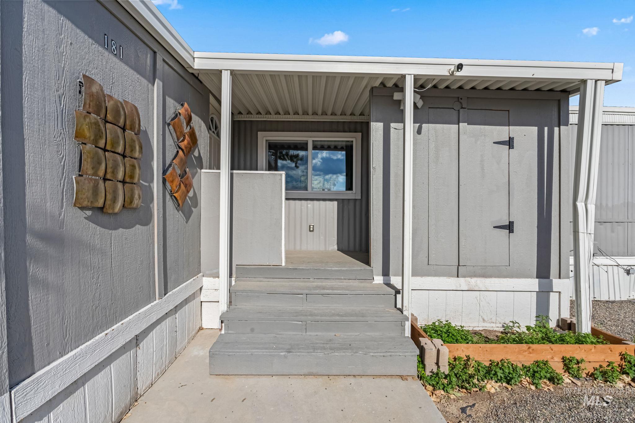 Entrance to property featuring covered porch