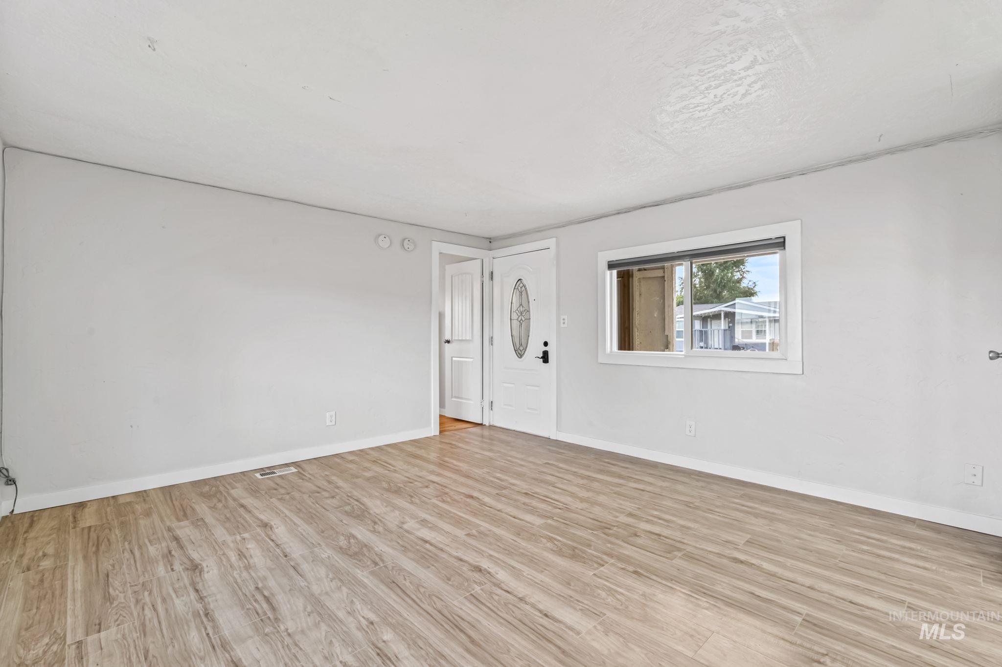 Unfurnished room with light wood-style flooring